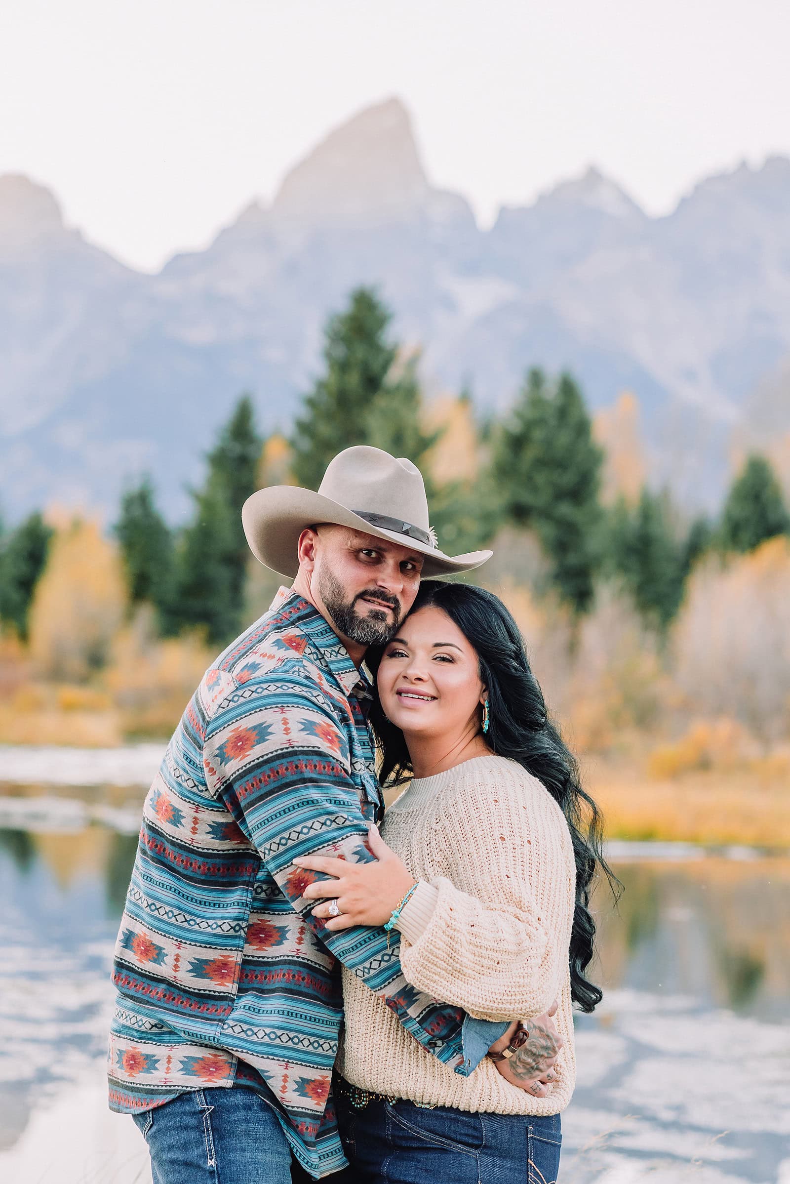 couple wearing custom engraved western hats at Grand Teton elopement turquoise wedding jewelry details at Jackson Hole mountain wedding horseback riding wedding party tour at Spring Creek Ranch Wyoming Schwabacher Landing sunset elopement portraits in Grand Teton National Park casual outfit change for relaxed mountain elopement photos split day wedding coverage for destination elopement couples flexible elopement timeline for Jackson Hole micro wedding western jeans and sweater look for Wyoming vacation style portraits