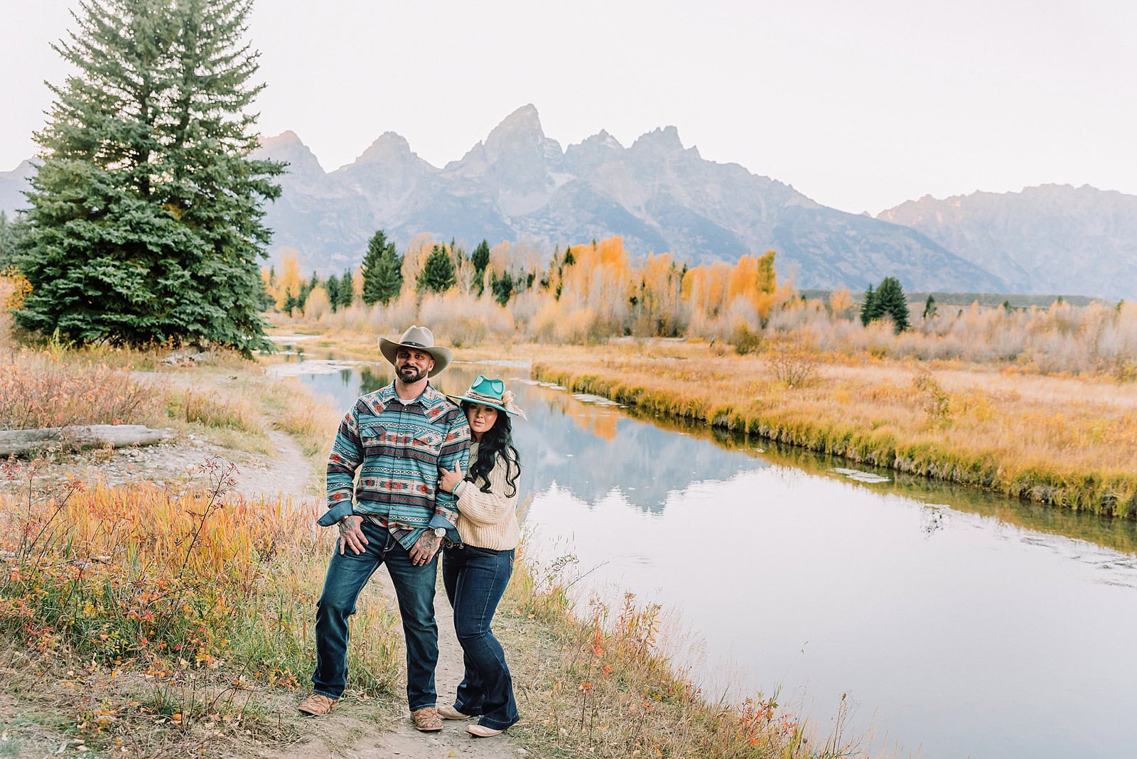 couple wearing custom engraved western hats at Grand Teton elopement turquoise wedding jewelry details at Jackson Hole mountain wedding horseback riding wedding party tour at Spring Creek Ranch Wyoming Schwabacher Landing sunset elopement portraits in Grand Teton National Park casual outfit change for relaxed mountain elopement photos split day wedding coverage for destination elopement couples flexible elopement timeline for Jackson Hole micro wedding western jeans and sweater look for Wyoming vacation style portraits