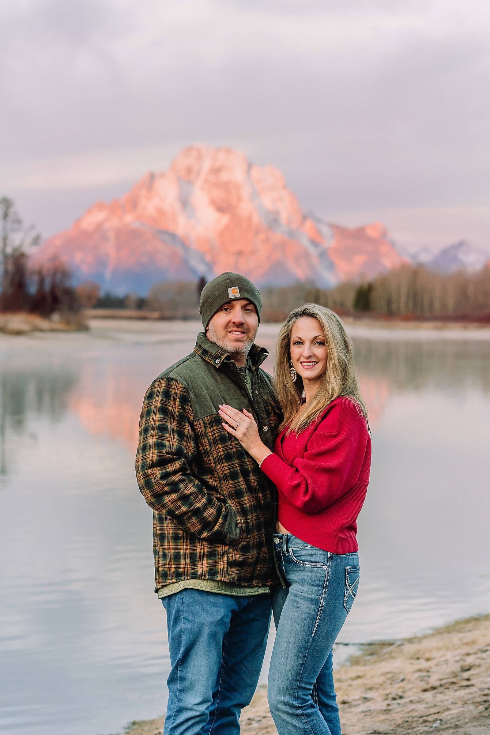 jackson hole anniversary photos at oxbow bend sunrise couple photography with fur coat jackson hole wyoming romantic river shoreline couples portraits grand teton national park october sunrise photography session oxbow bend