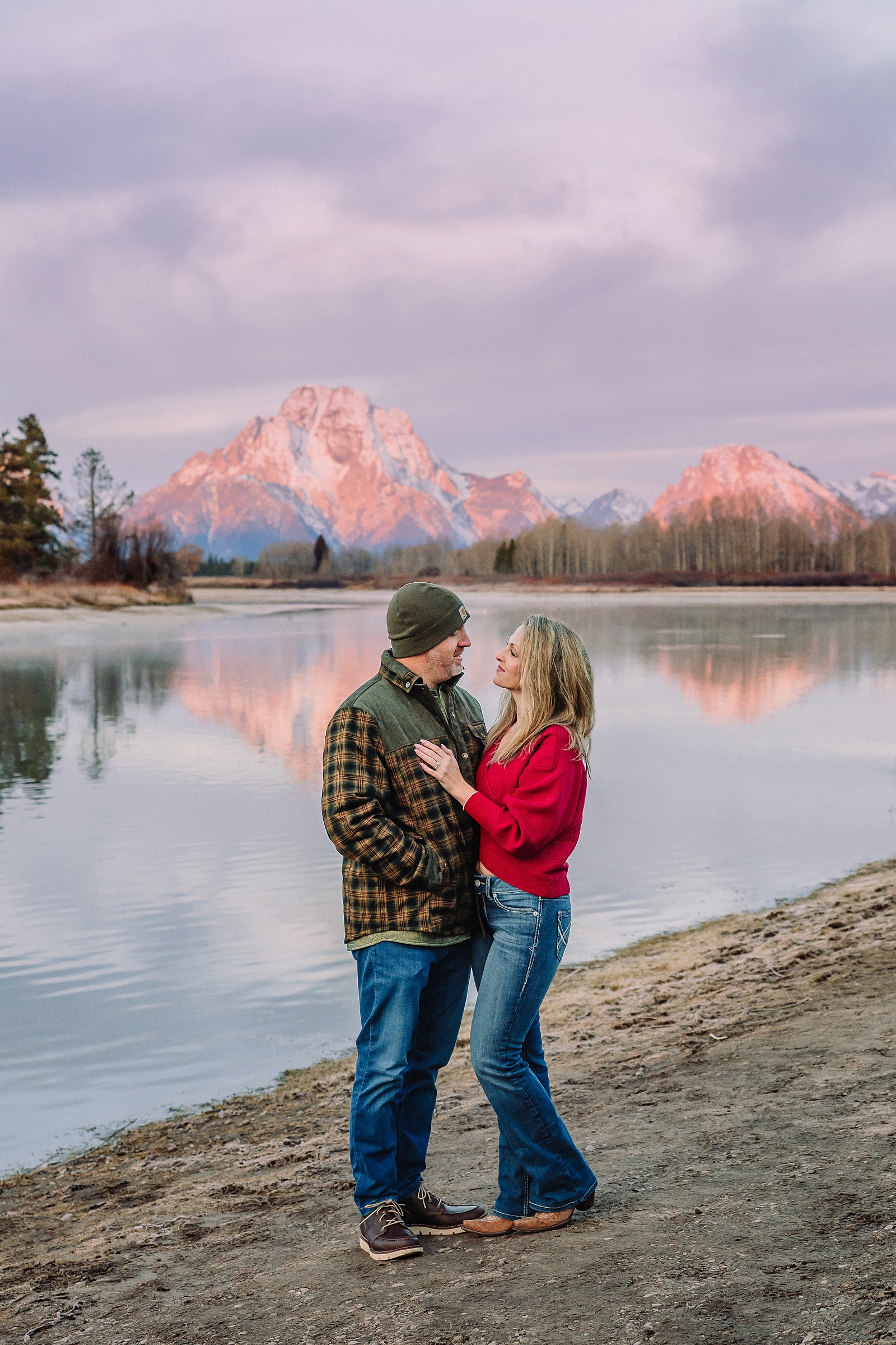jackson hole anniversary photos at oxbow bend sunrise couple photography with fur coat jackson hole wyoming romantic river shoreline couples portraits grand teton national park october sunrise photography session oxbow bend