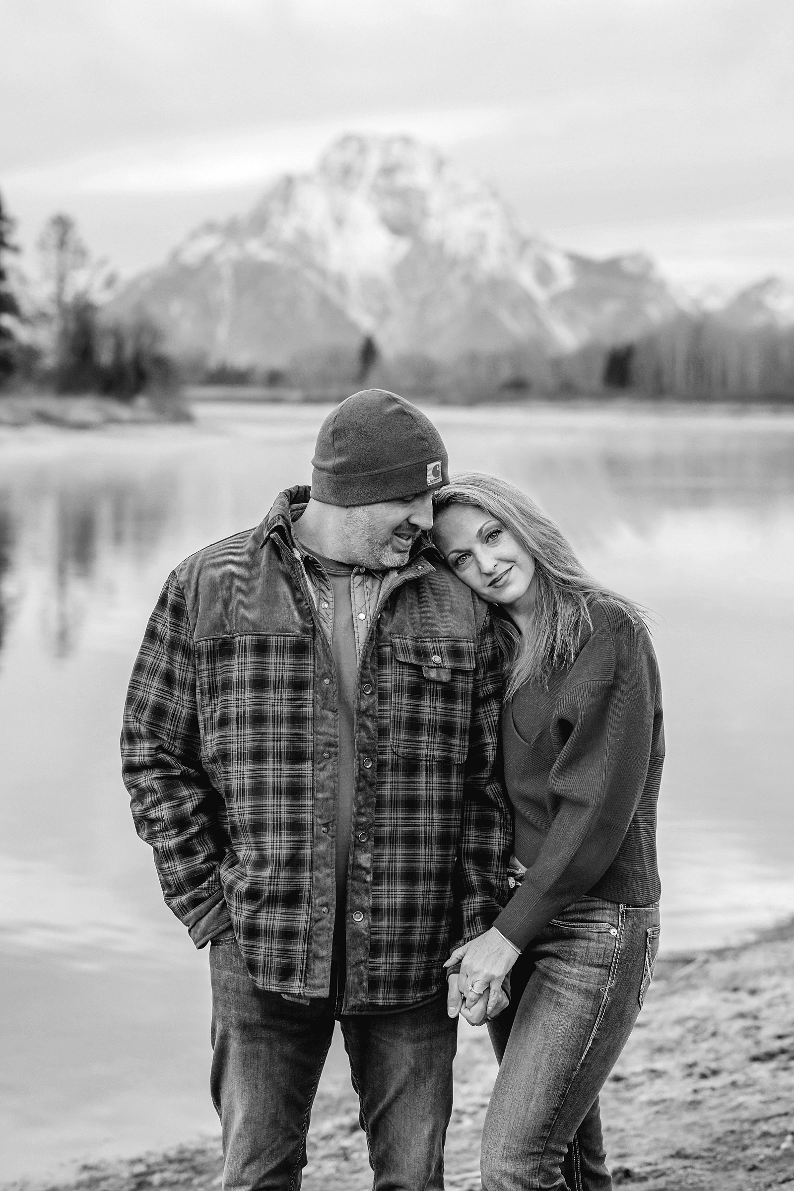 jackson hole anniversary photos at oxbow bend sunrise couple photography with fur coat jackson hole wyoming romantic river shoreline couples portraits grand teton national park october sunrise photography session oxbow bend