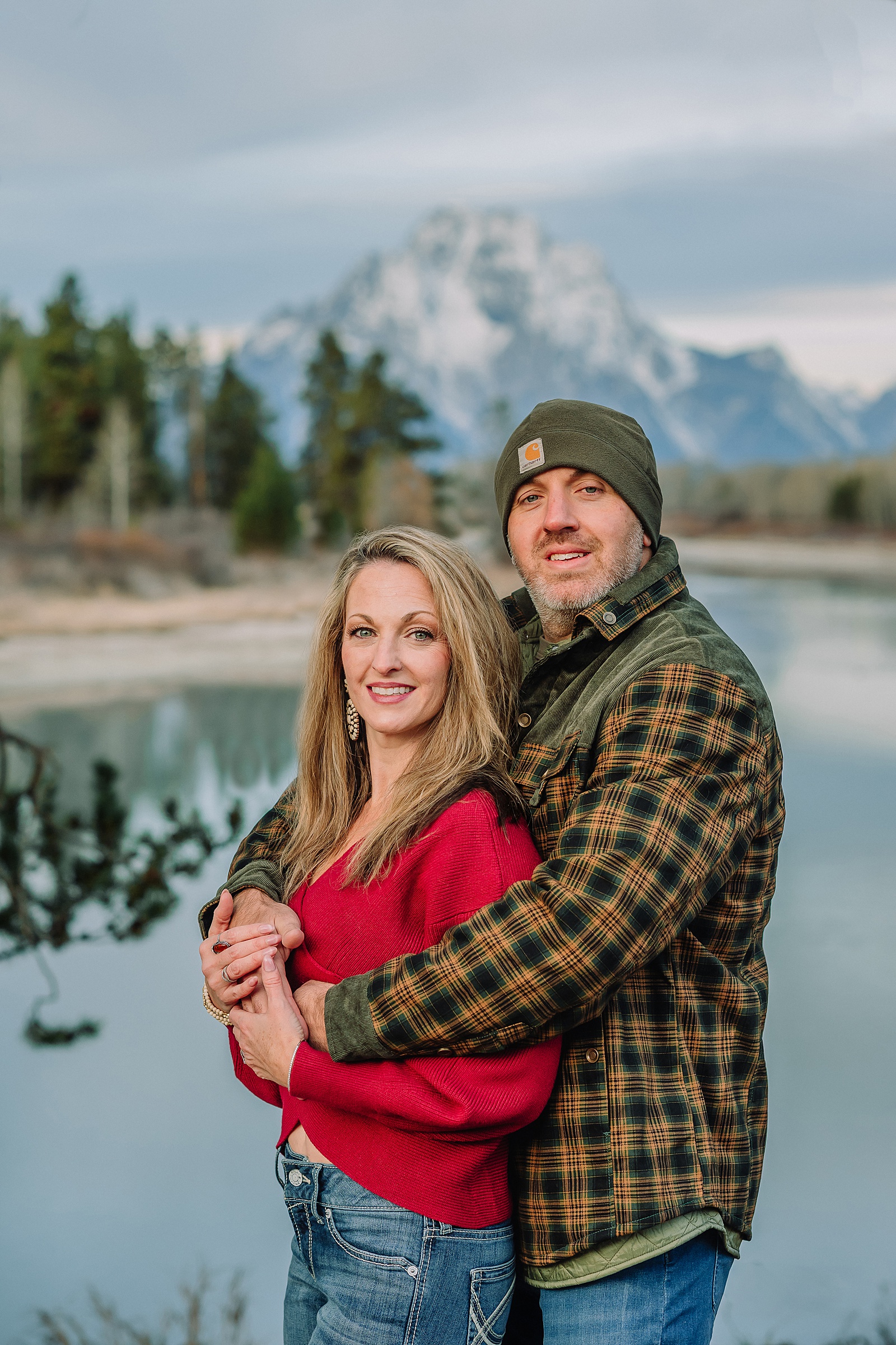 jackson hole anniversary photos at oxbow bend sunrise couple photography with fur coat jackson hole wyoming romantic river shoreline couples portraits grand teton national park october sunrise photography session oxbow bend