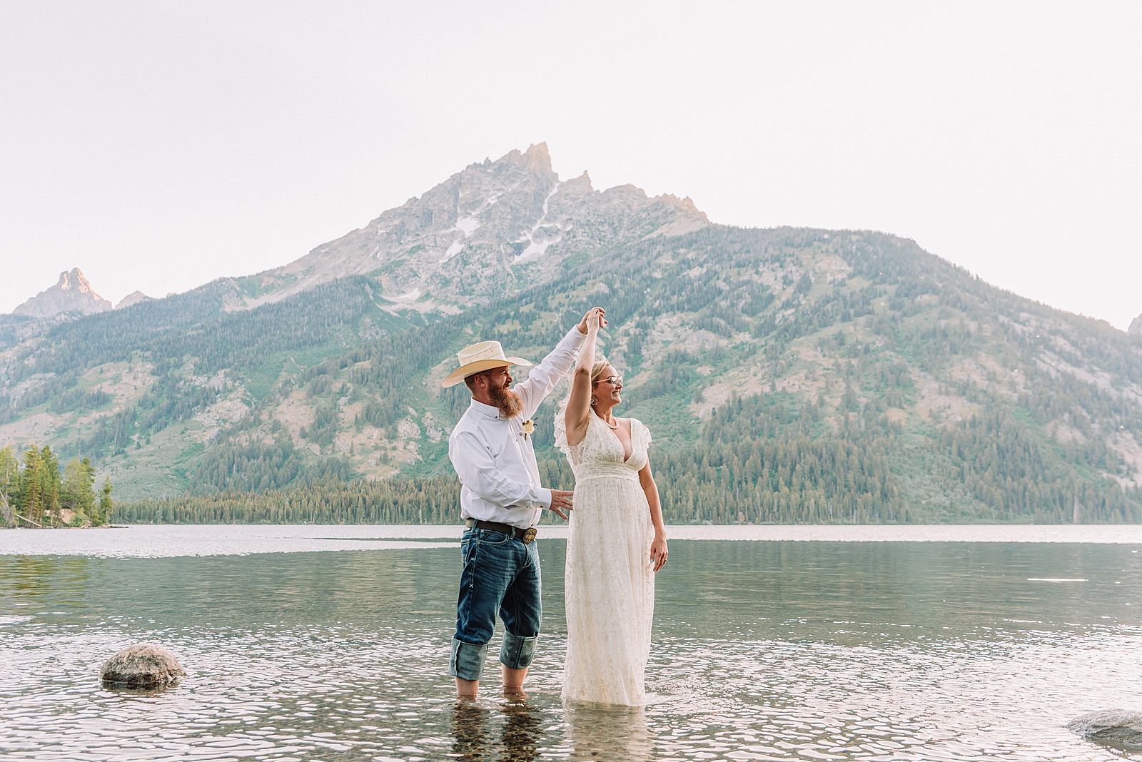 Jenny Lake vow renewal photography session romantic couples photos Jenny Lake Jackson Hole couple dancing in water Jenny Lake Wyoming mountain elopement with Teton backdrop Jackson Hole Photographer romantic Jackson Hole couple photography