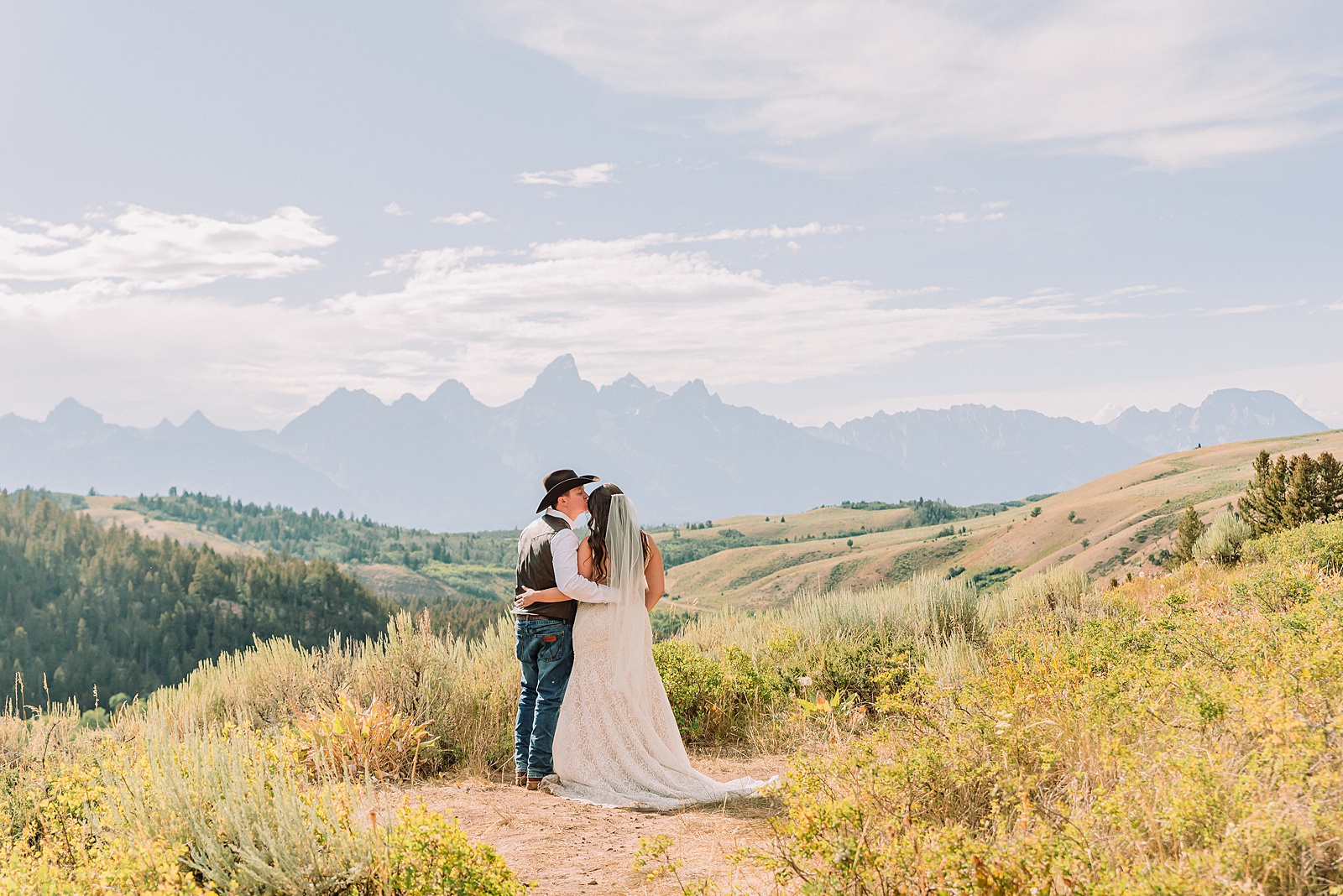 Bridger Teton National Forest outdoor wedding ceremony custom cowboy hat wedding surprise groom gift The Wedding Tree ceremony photos Wyoming champagne toast Grand Teton wedding celebration Jackson Hole Wedding Photographer