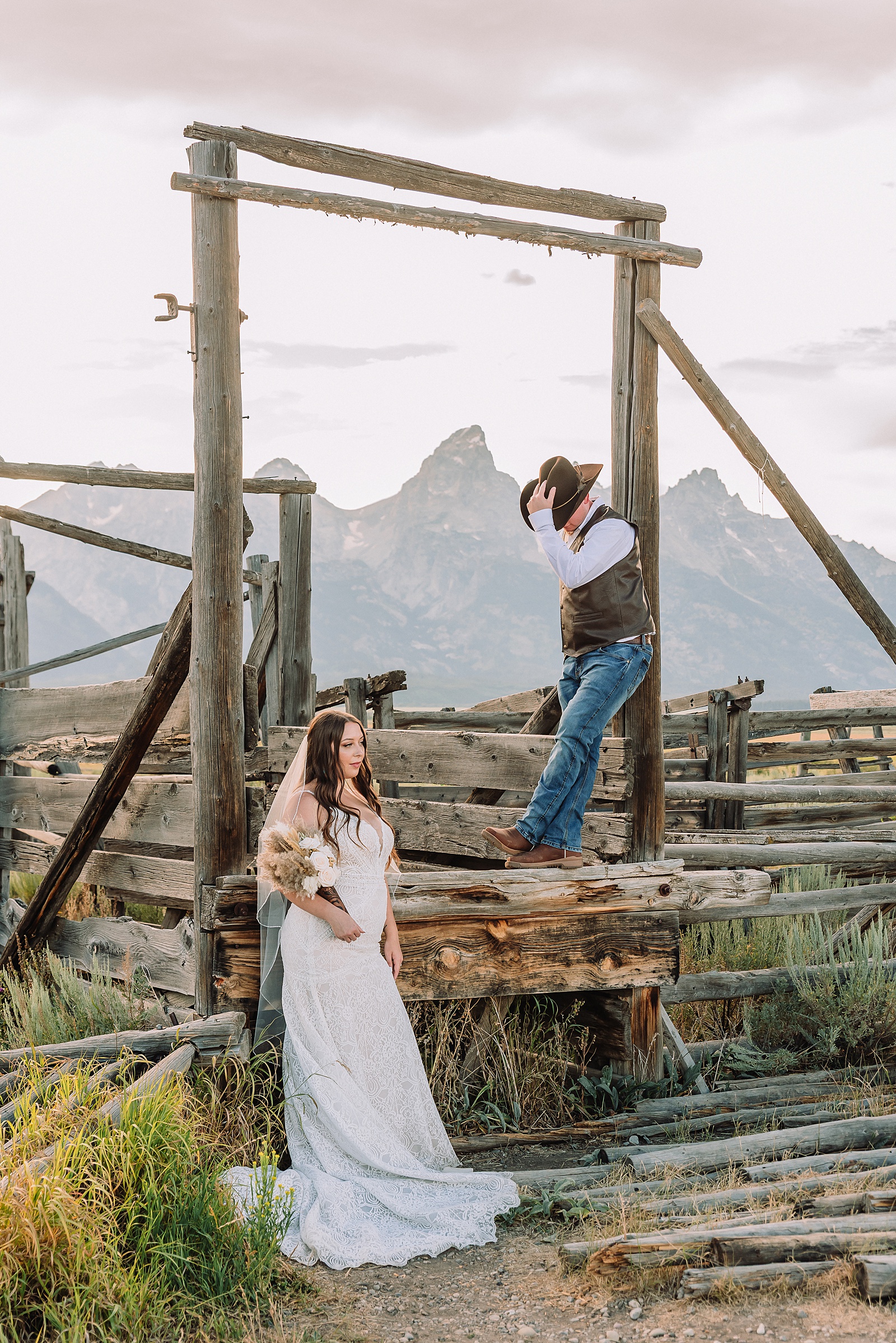 Jackson Hole wedding photographer barn photos Mormon Row western glam wedding dress deep neckline lace details mountain elopement with Teton backdrop intimate Jackson Hole wedding photography