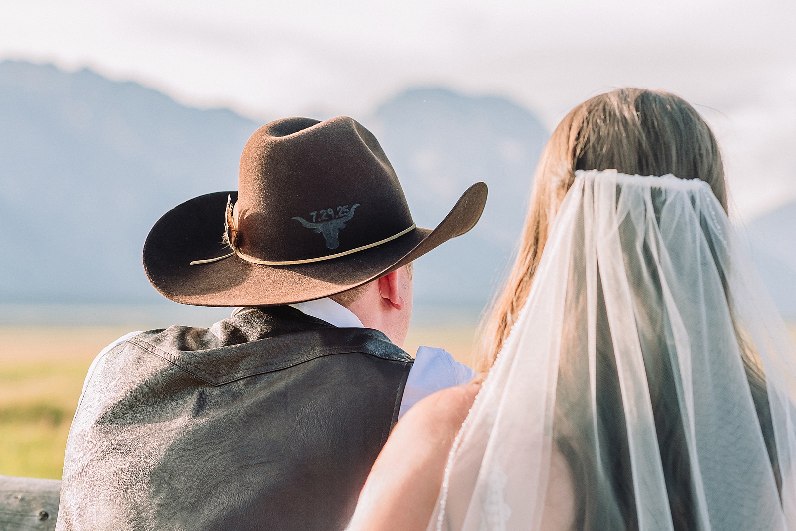 Jackson Hole wedding photographer barn photos Mormon Row western glam wedding dress deep neckline lace details mountain elopement with Teton backdrop intimate Jackson Hole wedding photography