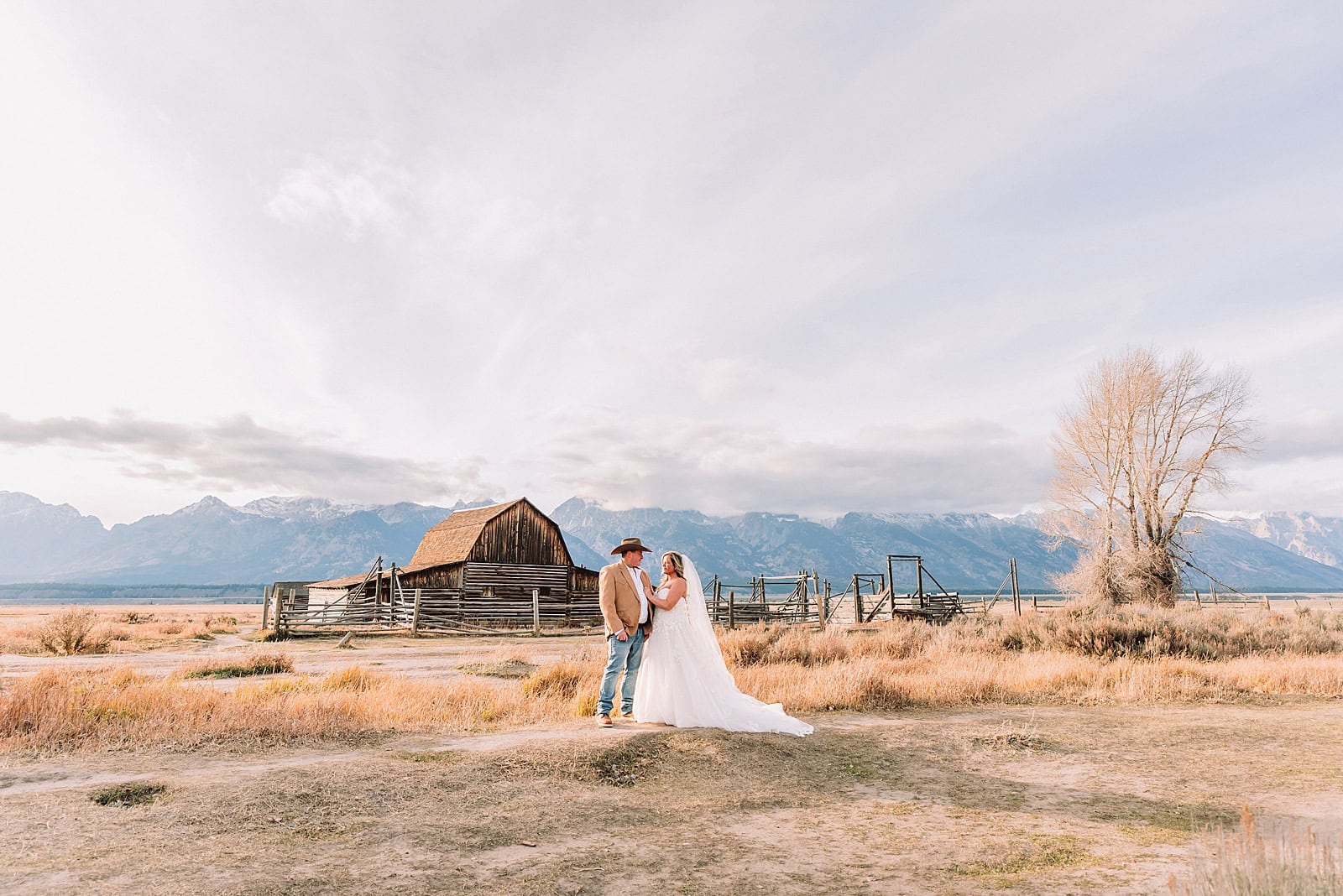 Mormon Row barn elopement photos with Grand Teton mountains fall elopement portraits at Mormon Row historic barns cowboy hat groom Mormon Row wedding photos Schwabacher Landing elopement reflection photos elopement ceremony Jackson Hole