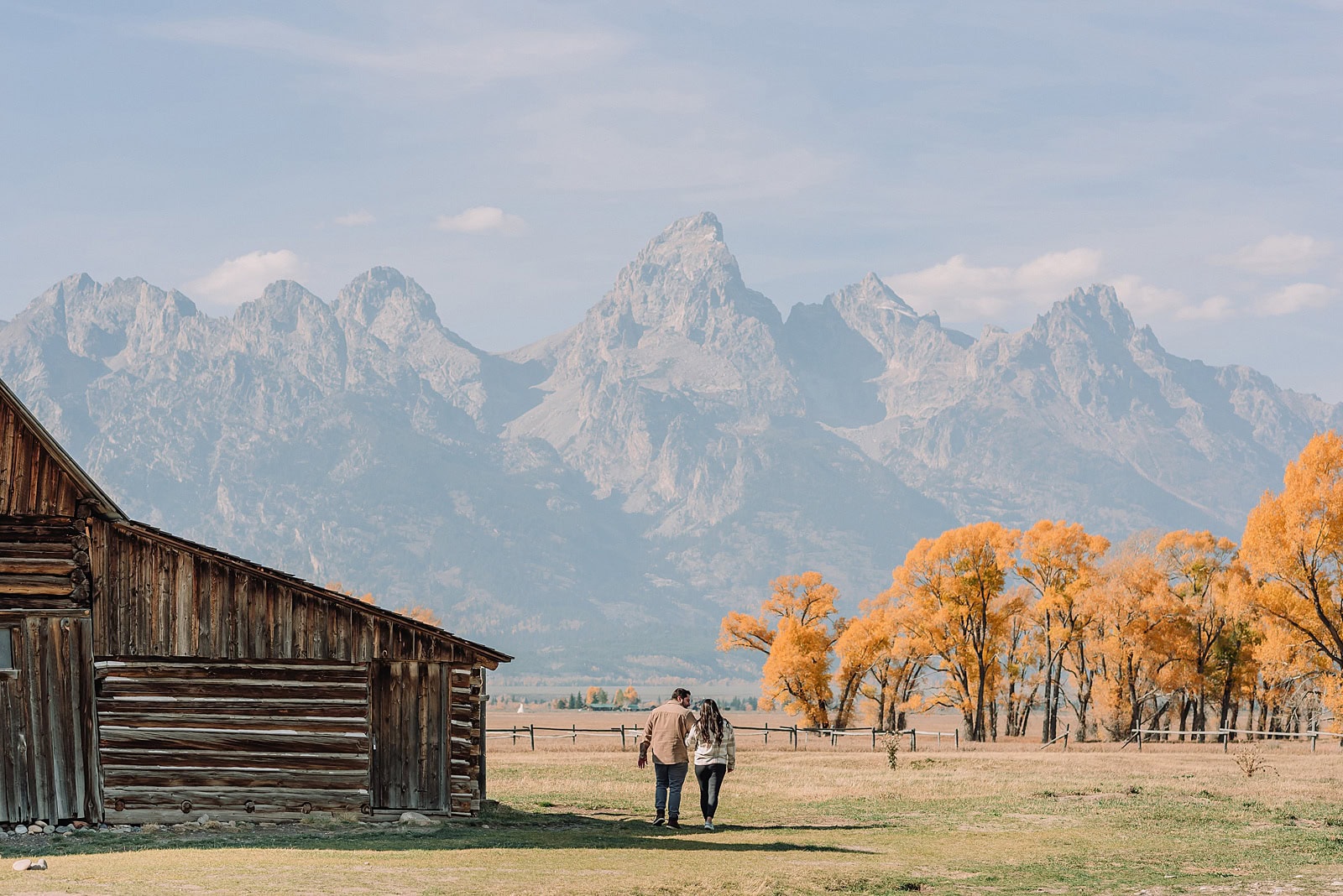 Grand Teton National Park proposal photographer Mormon Row barn proposal photos October proposal session in Jackson Hole surprise proposal at Mormon Row Tetons