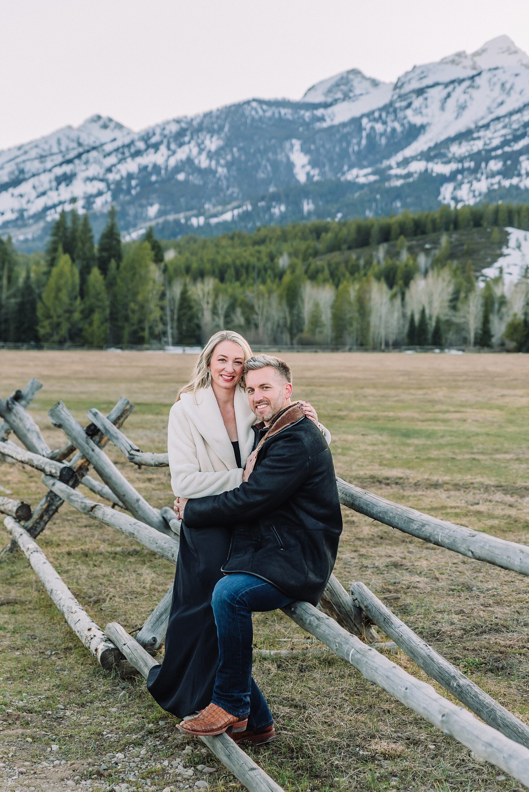 Luxury western couples photography Jackson Hole Early season mountain engagement photos Tetons Taggart Lake trailhead anniversary photography session Cascade bridge couples portraits Grand Teton National Park Faux fur coat mountain couples photoshoot Wyoming