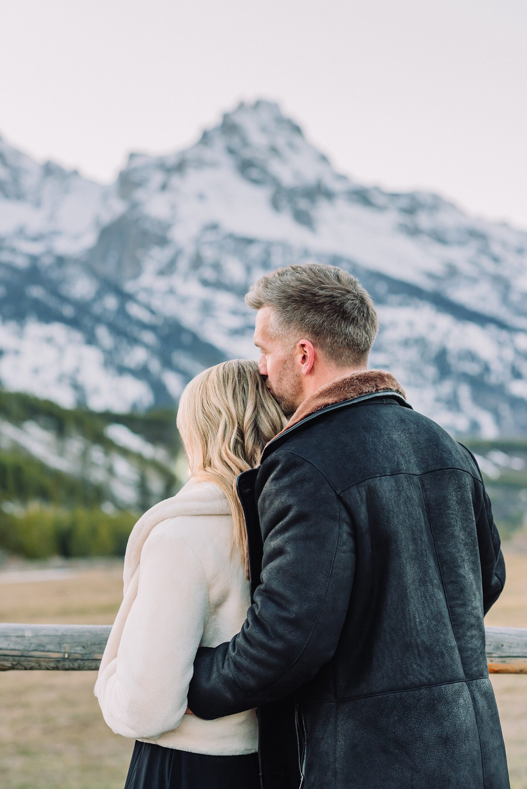 Grand Teton couples anniversary photos spring session Wyoming mountain bridge waterfall couple portraits Luxury western couples photography Jackson Hole Early season mountain engagement photos Tetons