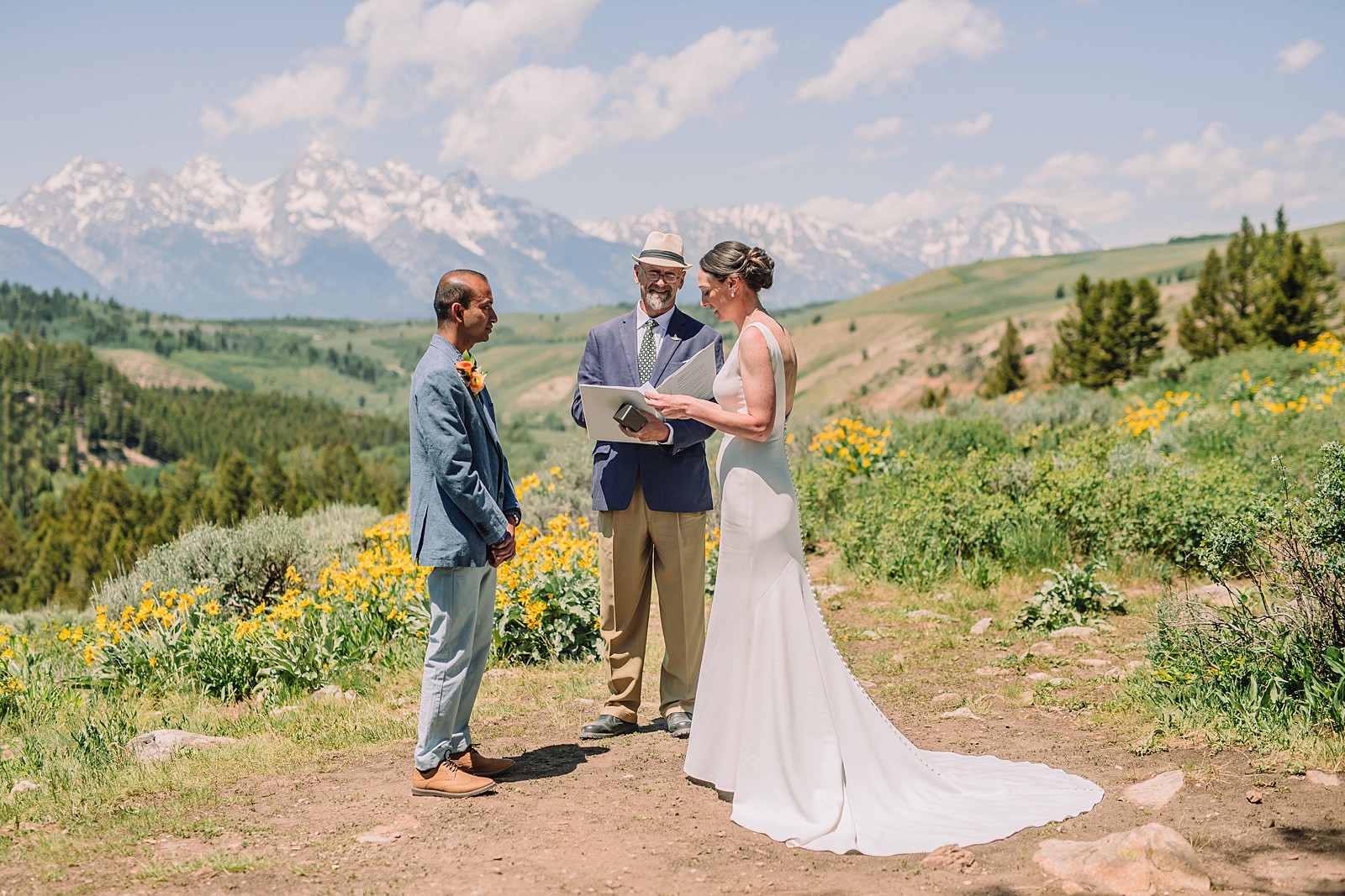 intimate Jackson Hole wedding photography The Wedding Tree ceremony photos Wyoming Wyoming mountain elopement at Wedding Tree June wildflower wedding ceremony Grand Tetons Wedding Tree elopement photographer Grand Teton National Park wildflower bouquet mountain wedding photography