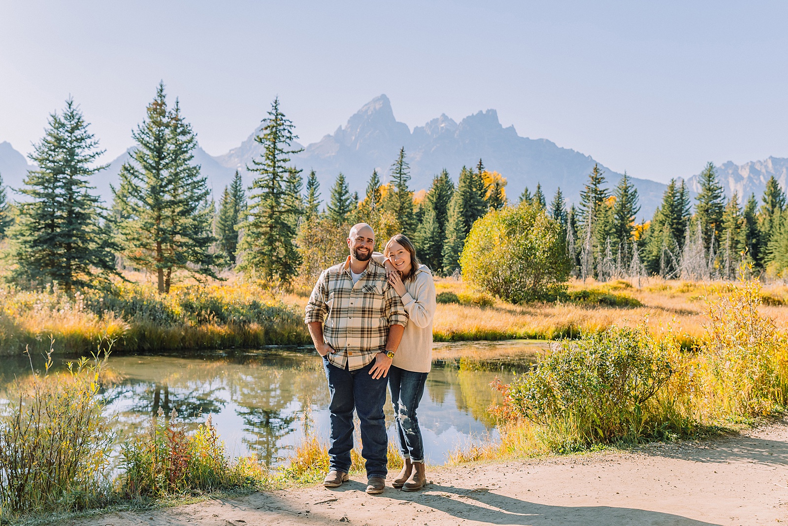 Buckrail fence rustic engagement portraits September Teton engagement photography golden hour Candid mountain couple photos engagement session Jackson Hole Photographer
