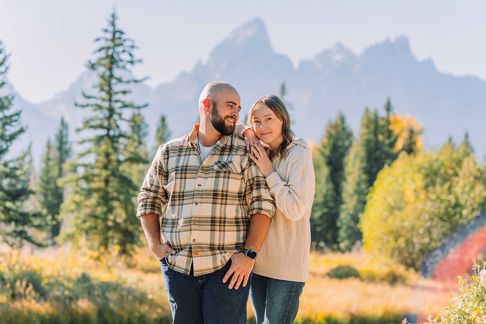 Buckrail fence rustic engagement portraits September Teton engagement photography golden hour Candid mountain couple photos engagement session Jackson Hole Photographer