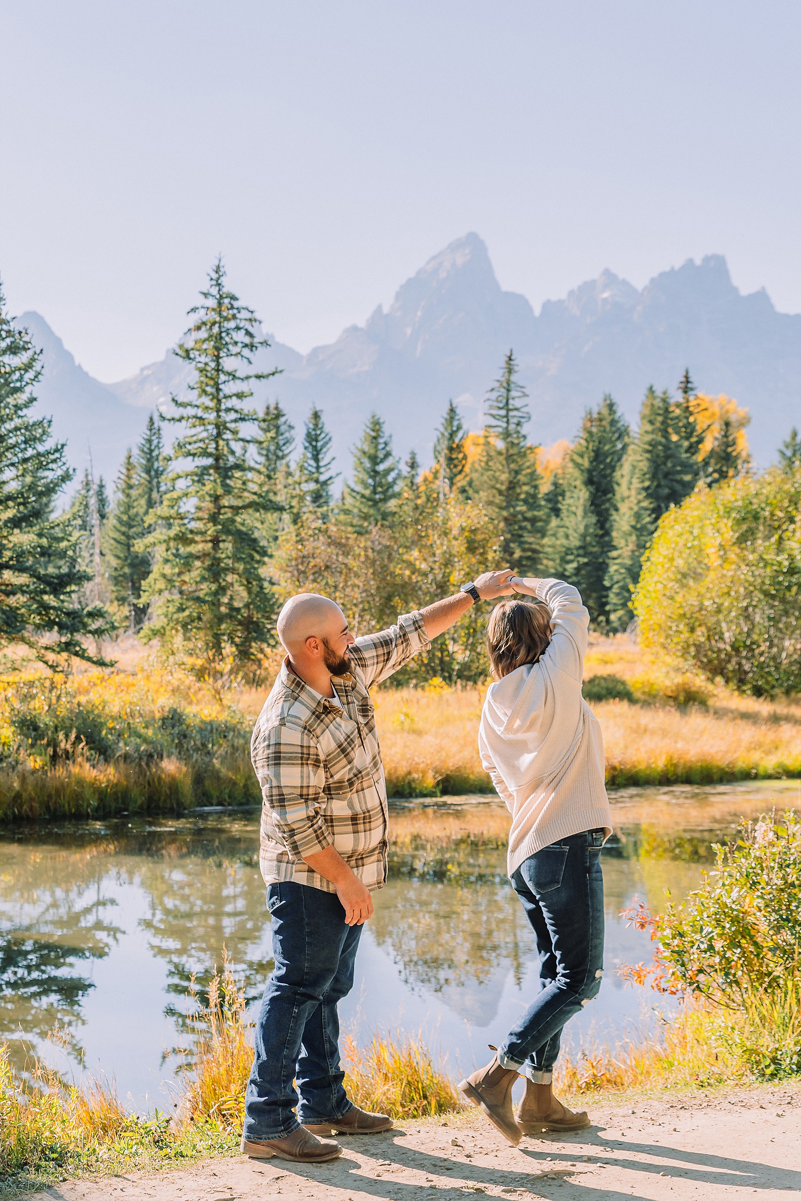 Buckrail fence rustic engagement portraits September Teton engagement photography golden hour Candid mountain couple photos engagement session Jackson Hole Photographer