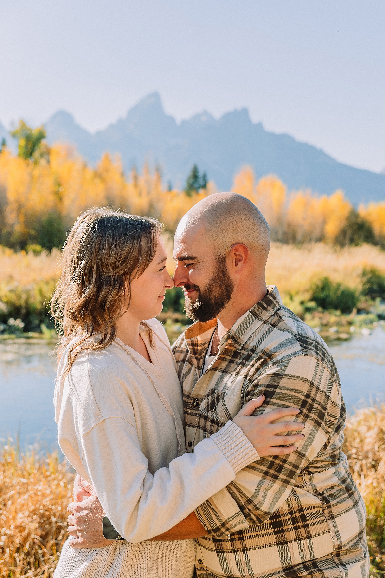 Jackson Hole Photographer Casual mountain engagement photos with jeans Fall engagement session Grand Tetons Wyoming Cream sweater engagement photos mountain backdrop