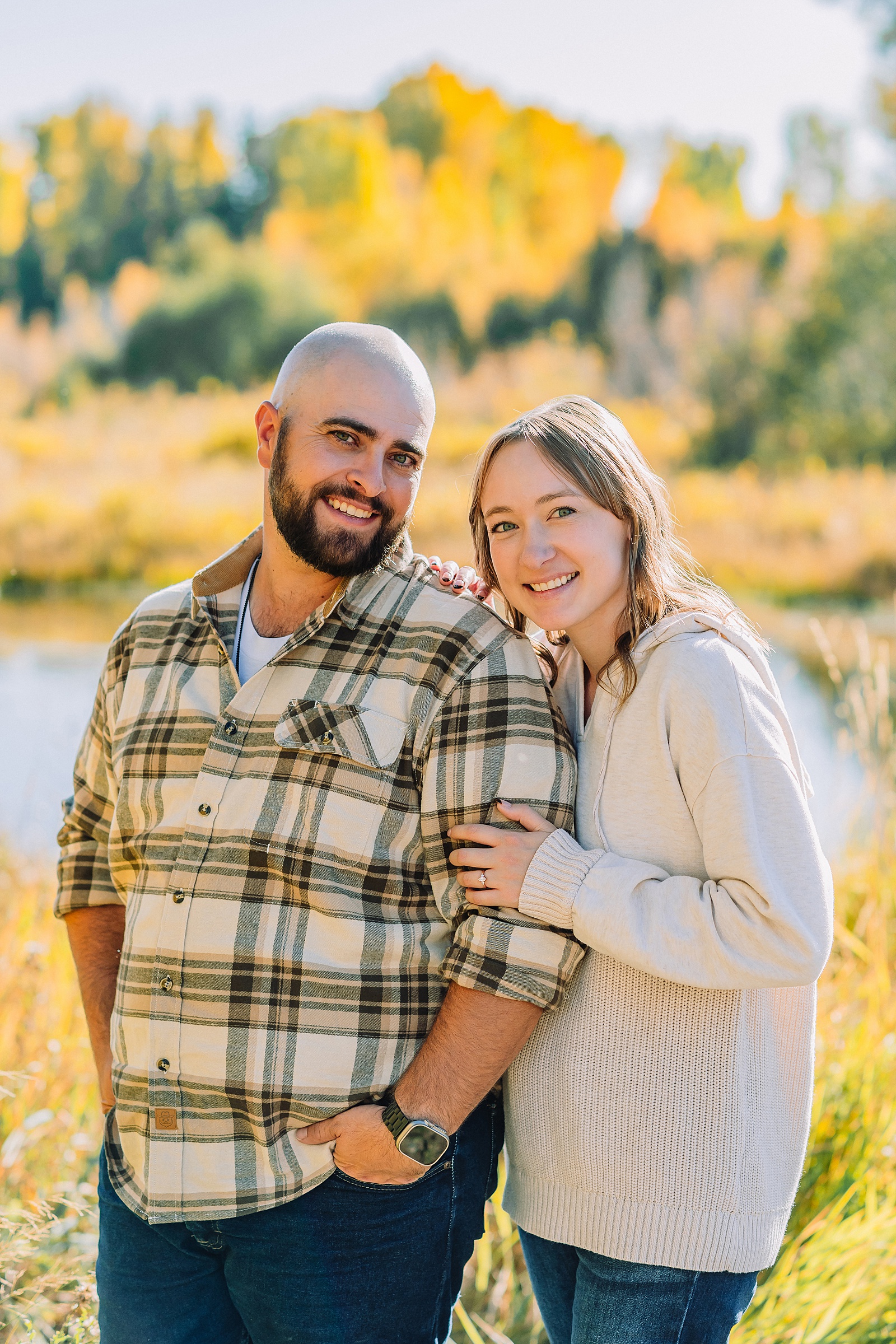 Casual mountain engagement photos with jeans Fall engagement session Grand Tetons Wyoming Cream sweater engagement photos mountain backdrop September Teton engagement photography golden hour Candid mountain couple photos engagement session