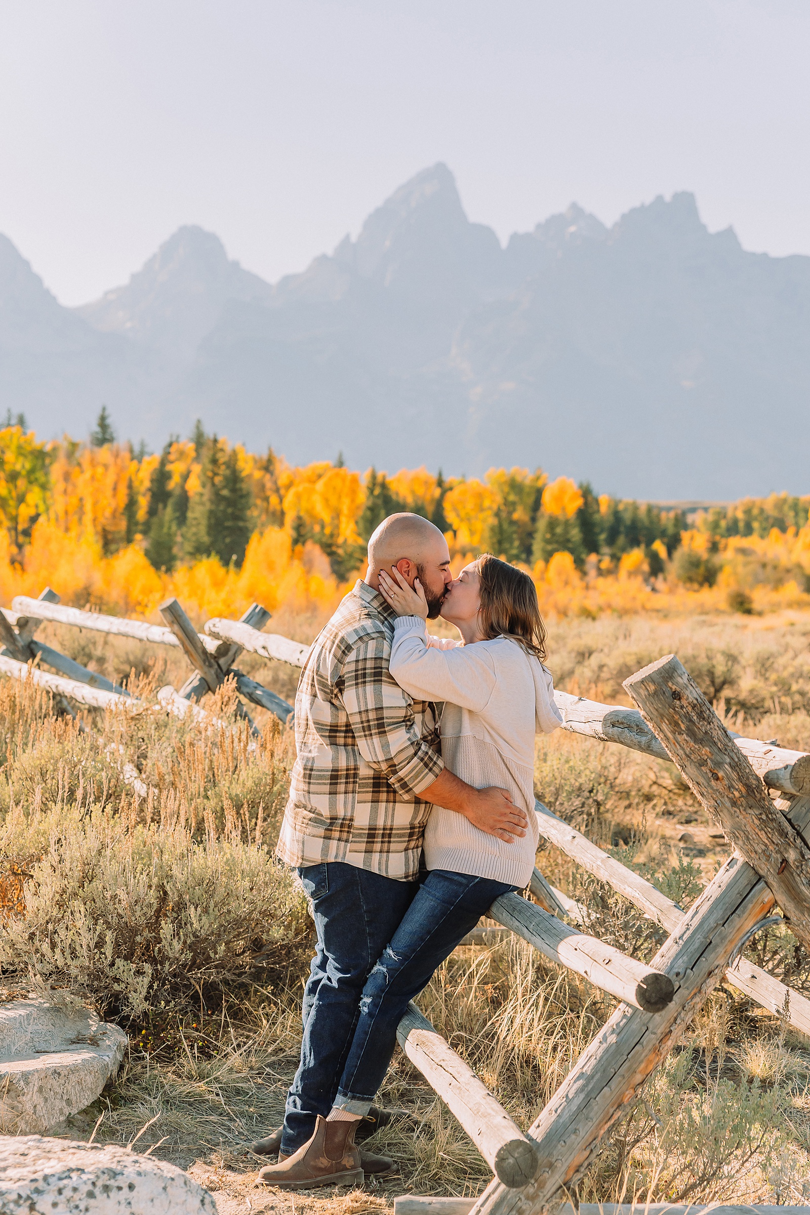 Casual mountain engagement photos with jeans Fall engagement session Grand Tetons Wyoming Cream sweater engagement photos mountain backdrop September Teton engagement photography golden hour Candid mountain couple photos engagement session