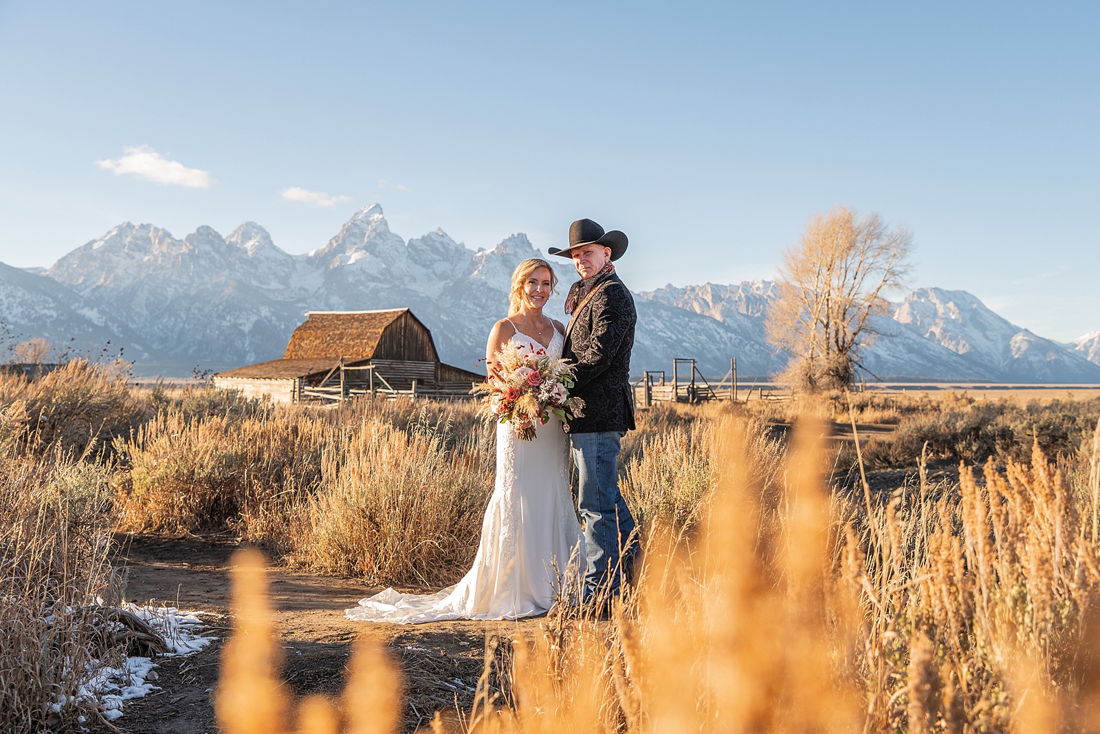 Mormon Row wedding portraits golden hour Rustic mountain wedding with Teton backdrop Cowboy themed groom style mountain wedding Vintage barn wedding photos Jackson Hole
