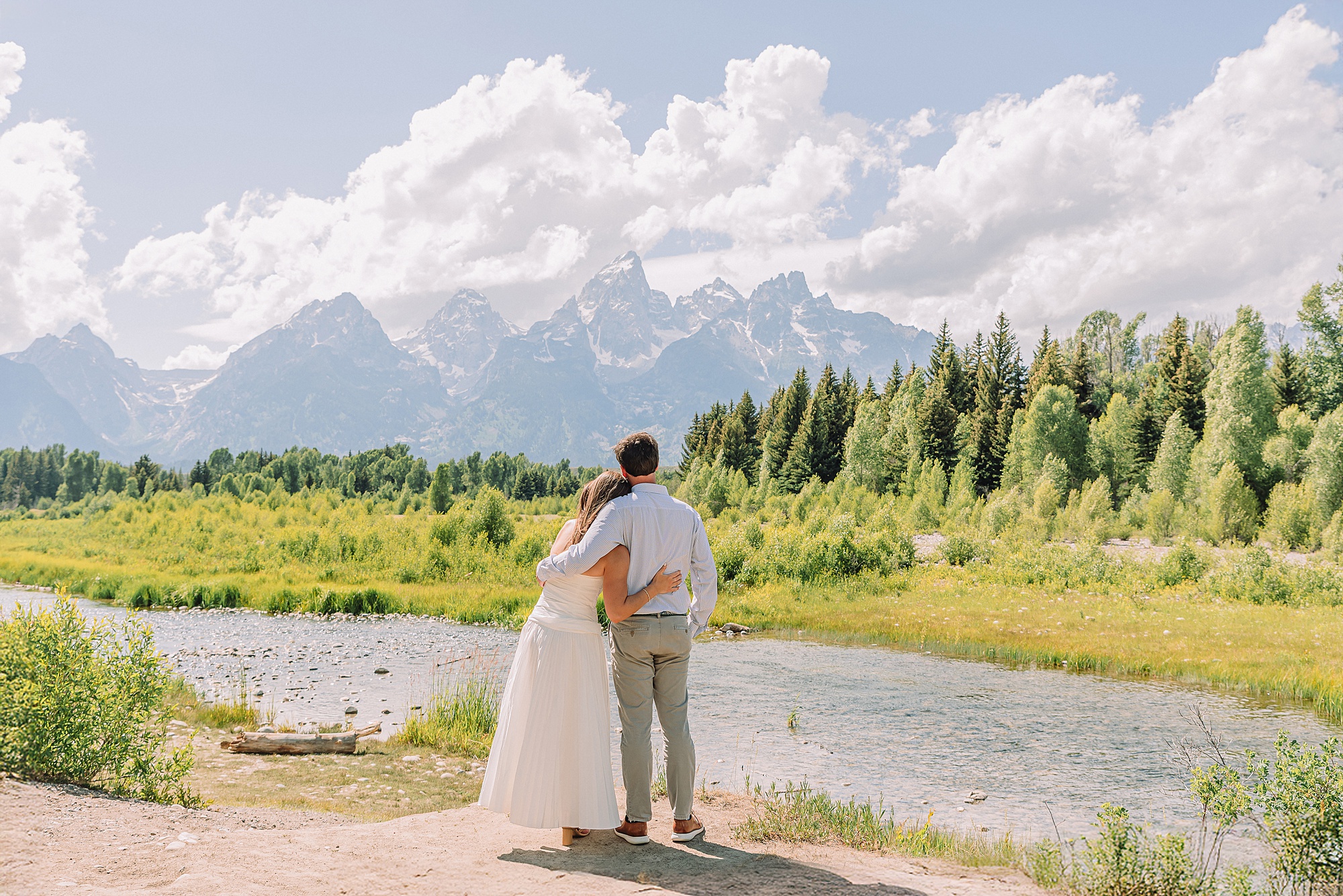 mountain engagement session with river views Grand Tetons white dress engagement photos in nature shaded forest engagement photos summer session romantic nature engagement session July Wyoming
