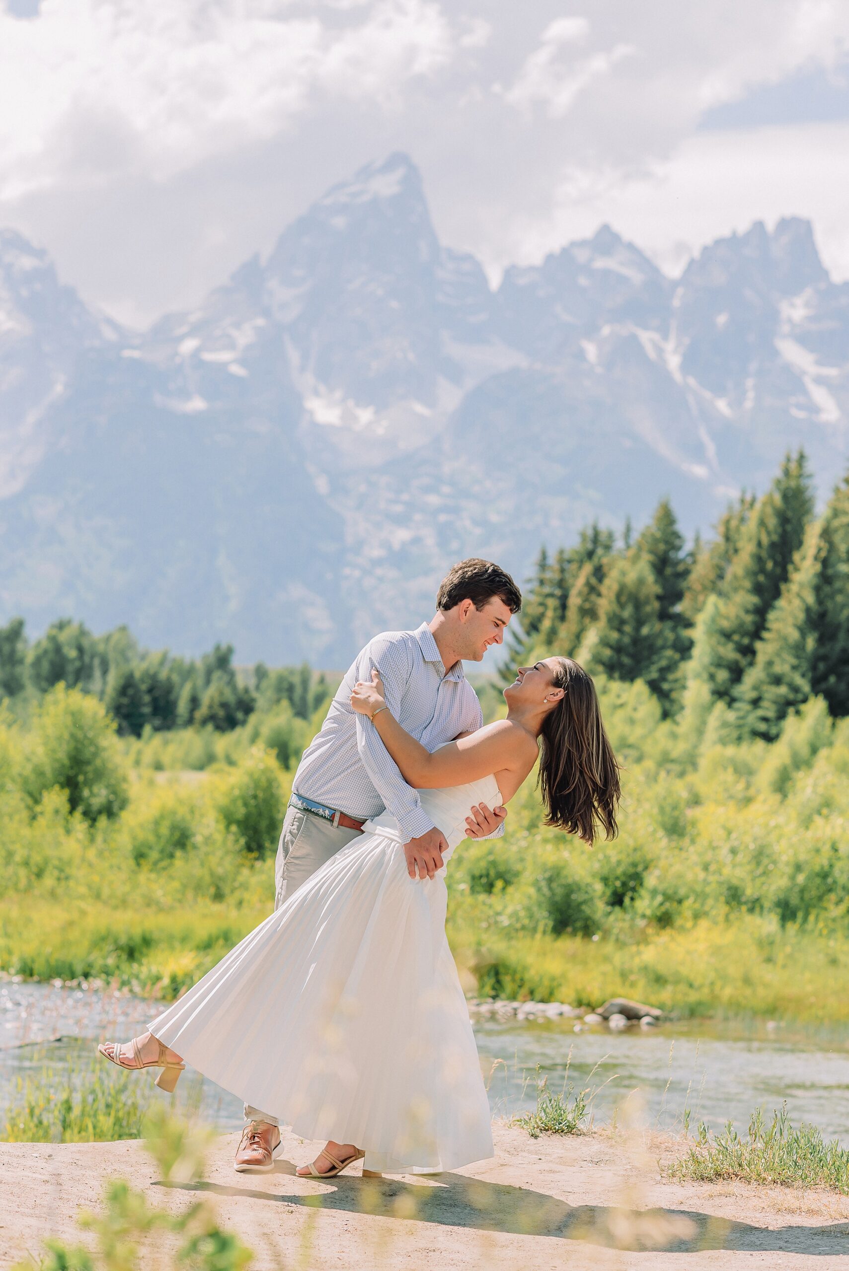 mountain engagement session with river views Grand Tetons white dress engagement photos in nature shaded forest engagement photos summer session romantic nature engagement session July Wyoming