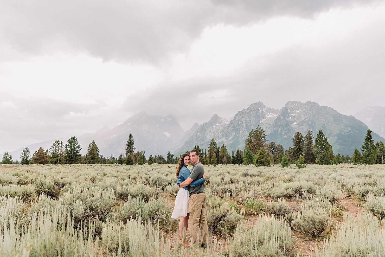 outdoor family photos with baby Grand Tetons purple western shirt family portraits Wyoming cream plaid toddler outdoor photos mountains flexible outdoor photography session inclement weather Jackson Hole Photographer Grand Teton National Park family photographer