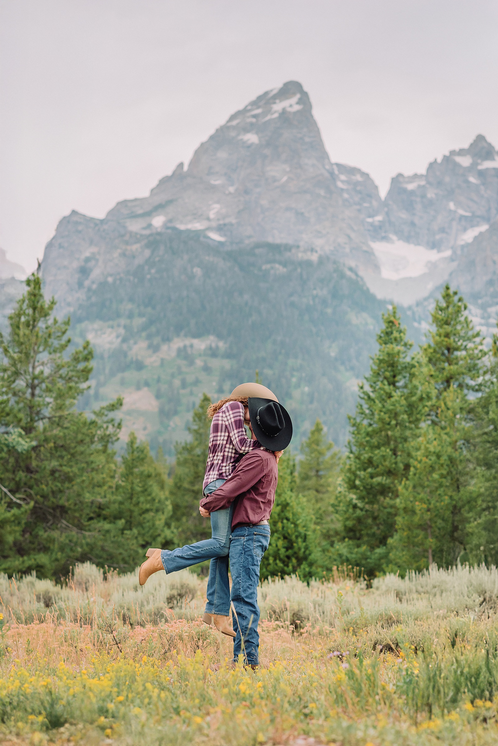 outdoor family photos with baby Grand Tetons purple western shirt family portraits Wyoming cream plaid toddler outdoor photos mountains flexible outdoor photography session inclement weather Jackson Hole Photographer Grand Teton National Park family photographer