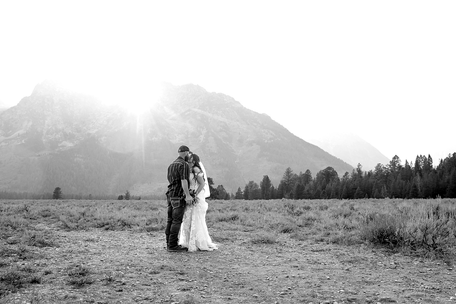 Teton Mountains elopement photography intimate ceremony Cathedral View Turnout wedding photographer Wyoming bride with white cowgirl boots mountain wedding intimate family elopement Teton National Park