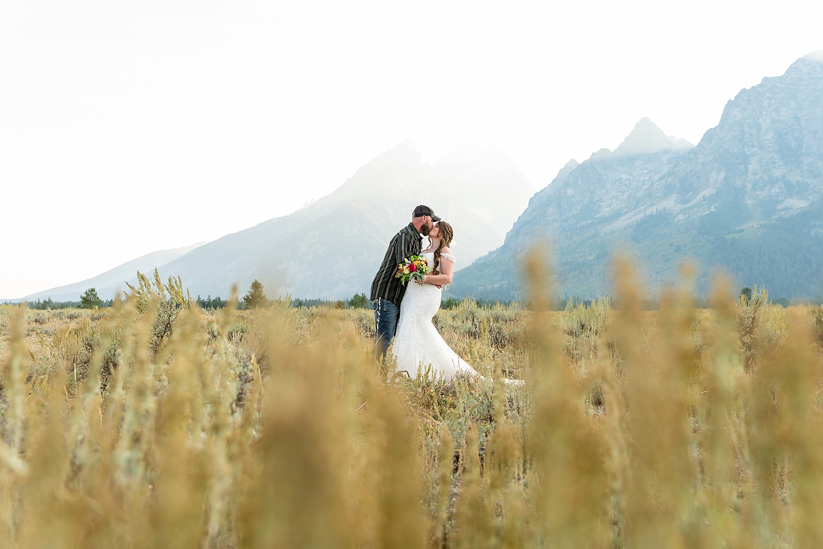 Teton Mountains elopement photography intimate ceremony Cathedral View Turnout wedding photographer Wyoming bride with white cowgirl boots mountain wedding intimate family elopement Teton National Park