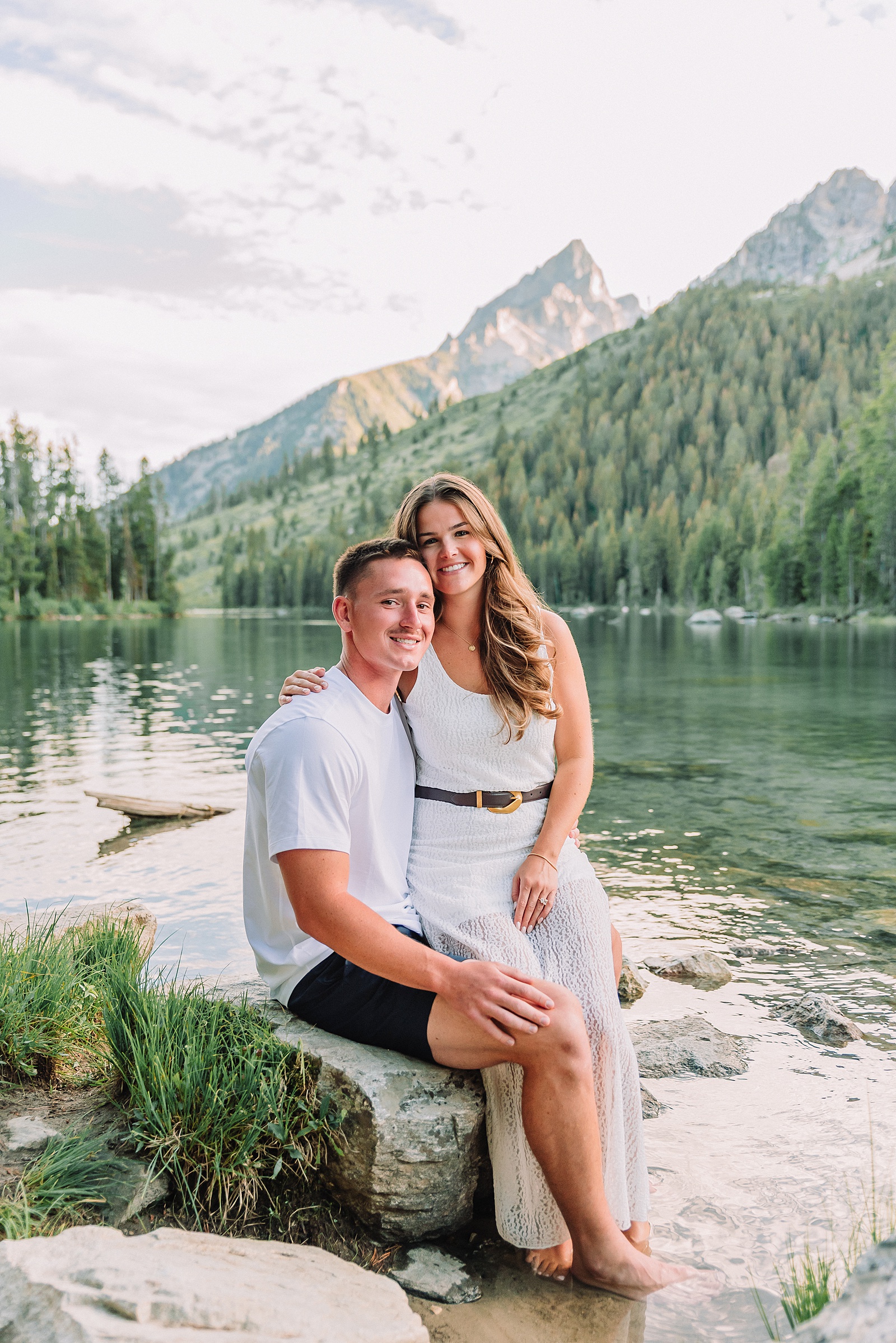 Jackson Hole Photographer casual mountain engagement session ideas dramatic Teton peaks engagement portraits playful couple poses mountain backdrop String Lake trailhead engagement pictures