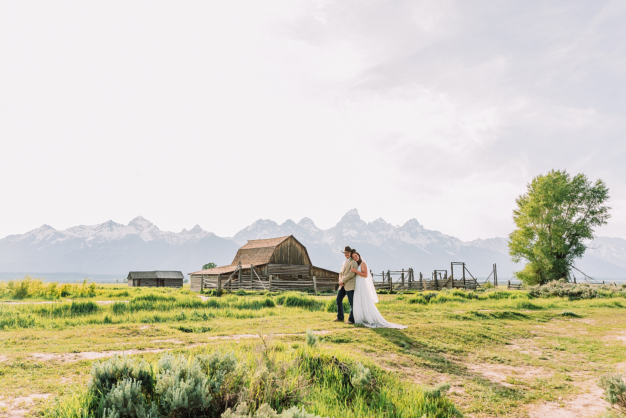 Jackson Hole Wyoming wedding photography Jackson Hole wedding photography Mormon Row portraits Bride fringed jean jacket Western wedding style Mormon Row Rustic Barn Wedding