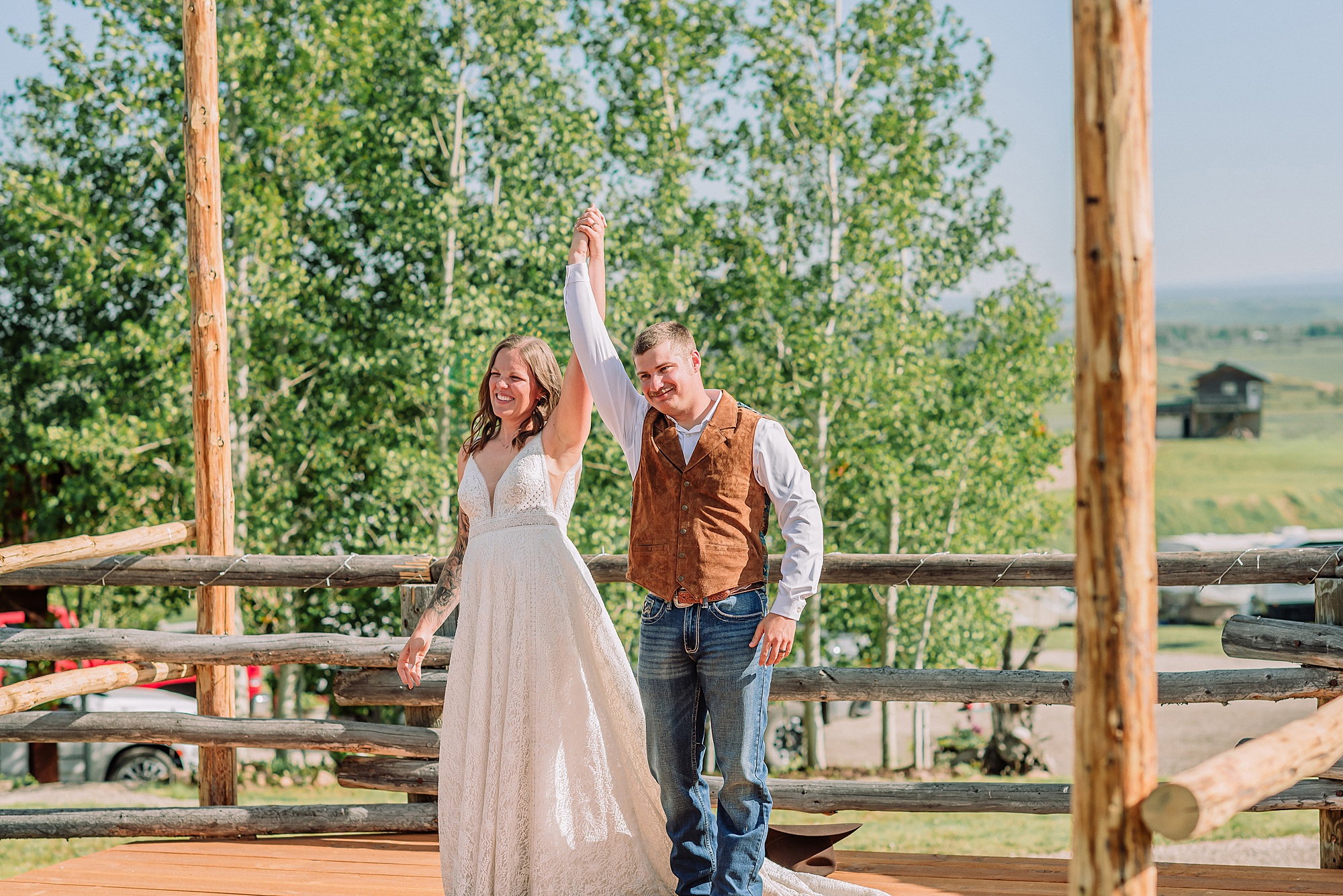Rustic Wyoming outdoor wedding reception dance floor Faith-based knot tying wedding ceremony Wyoming Candid hilarious cake cutting wedding photos Two-day Wyoming wedding ceremony and reception photography destination Wyoming wedding photography