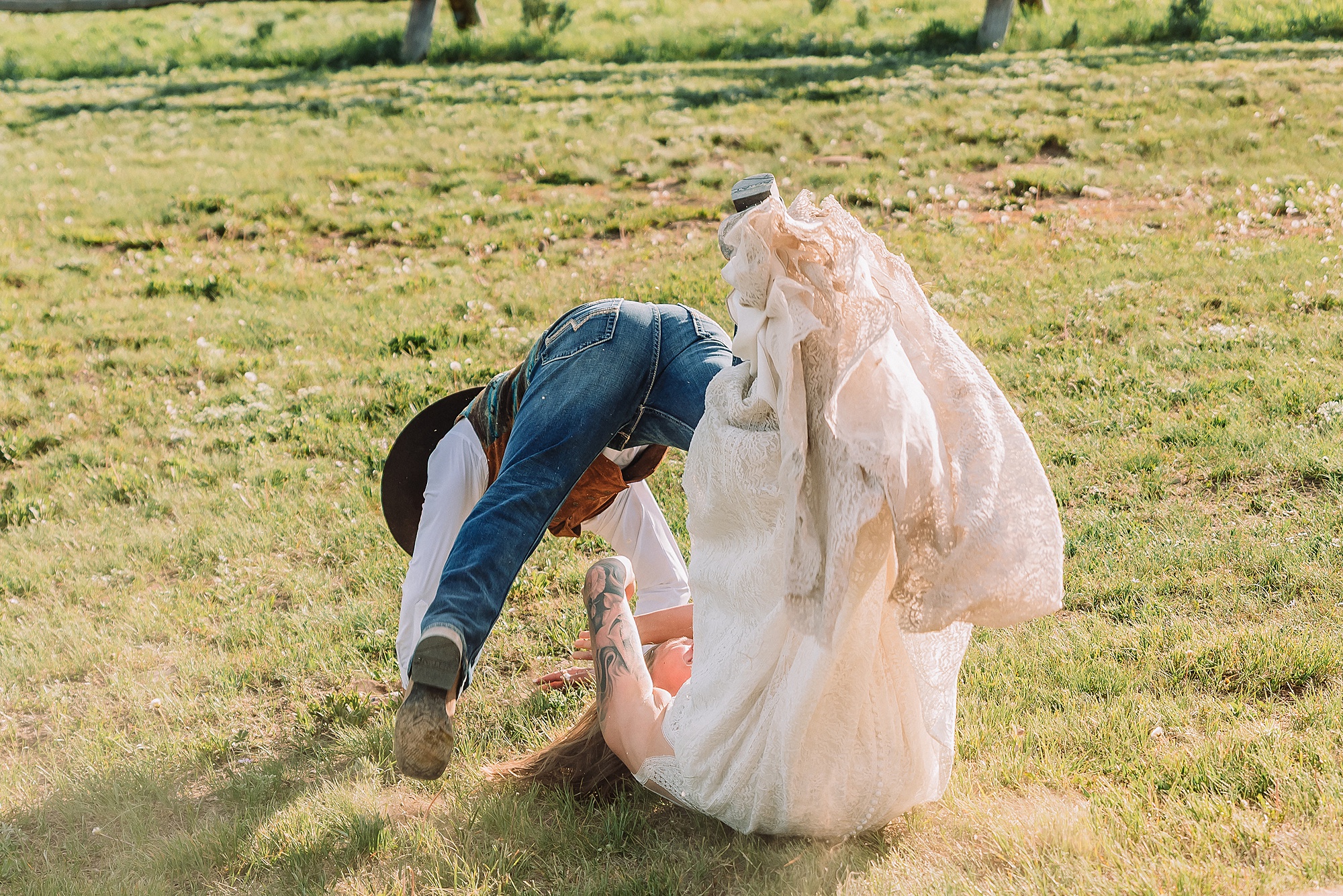 Rustic Wyoming outdoor wedding reception dance floor Faith-based knot tying wedding ceremony Wyoming Candid hilarious cake cutting wedding photos Two-day Wyoming wedding ceremony and reception photography destination Wyoming wedding photography