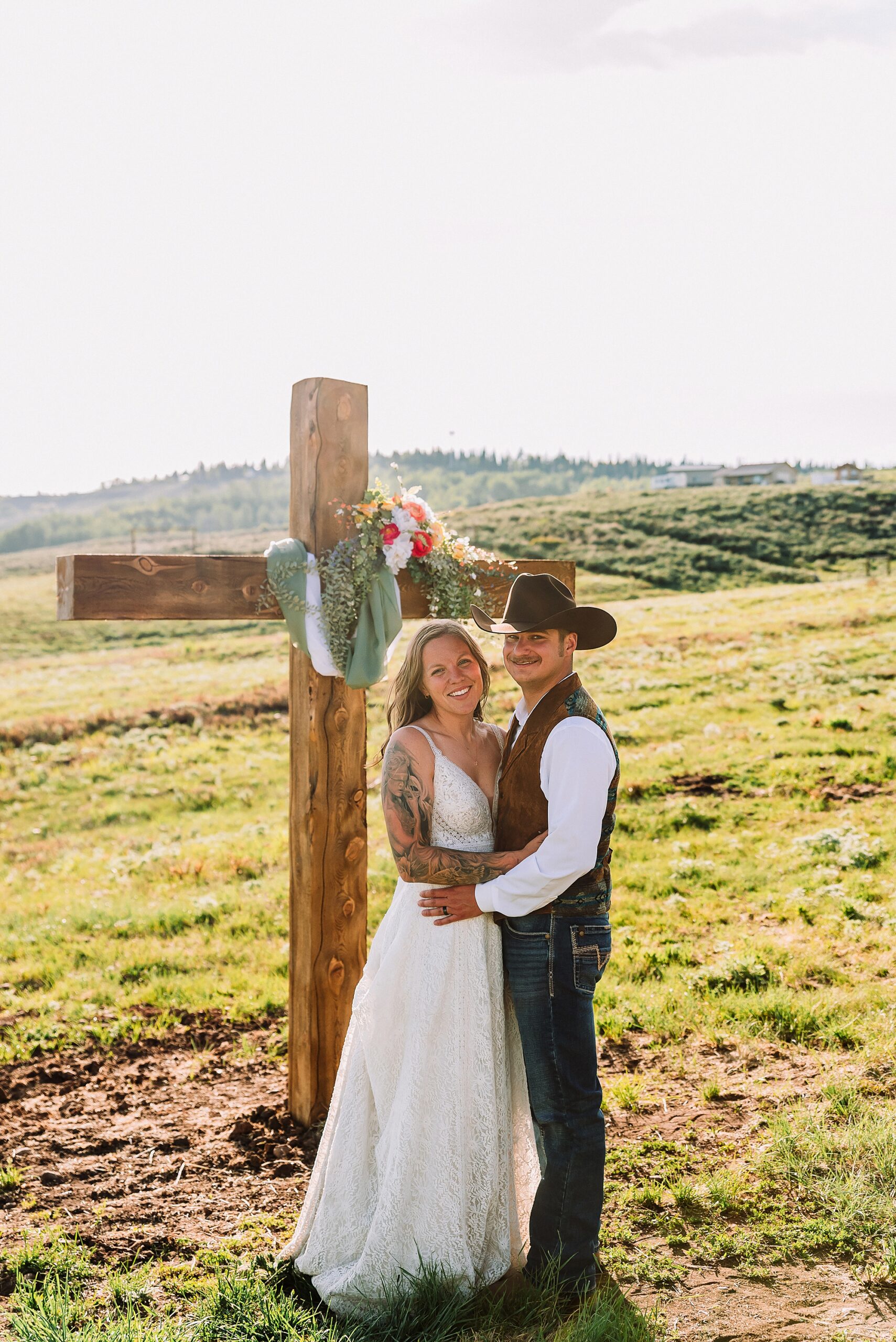 Rustic Wyoming outdoor wedding reception dance floor Faith-based knot tying wedding ceremony Wyoming Candid hilarious cake cutting wedding photos Two-day Wyoming wedding ceremony and reception photography destination Wyoming wedding photography
