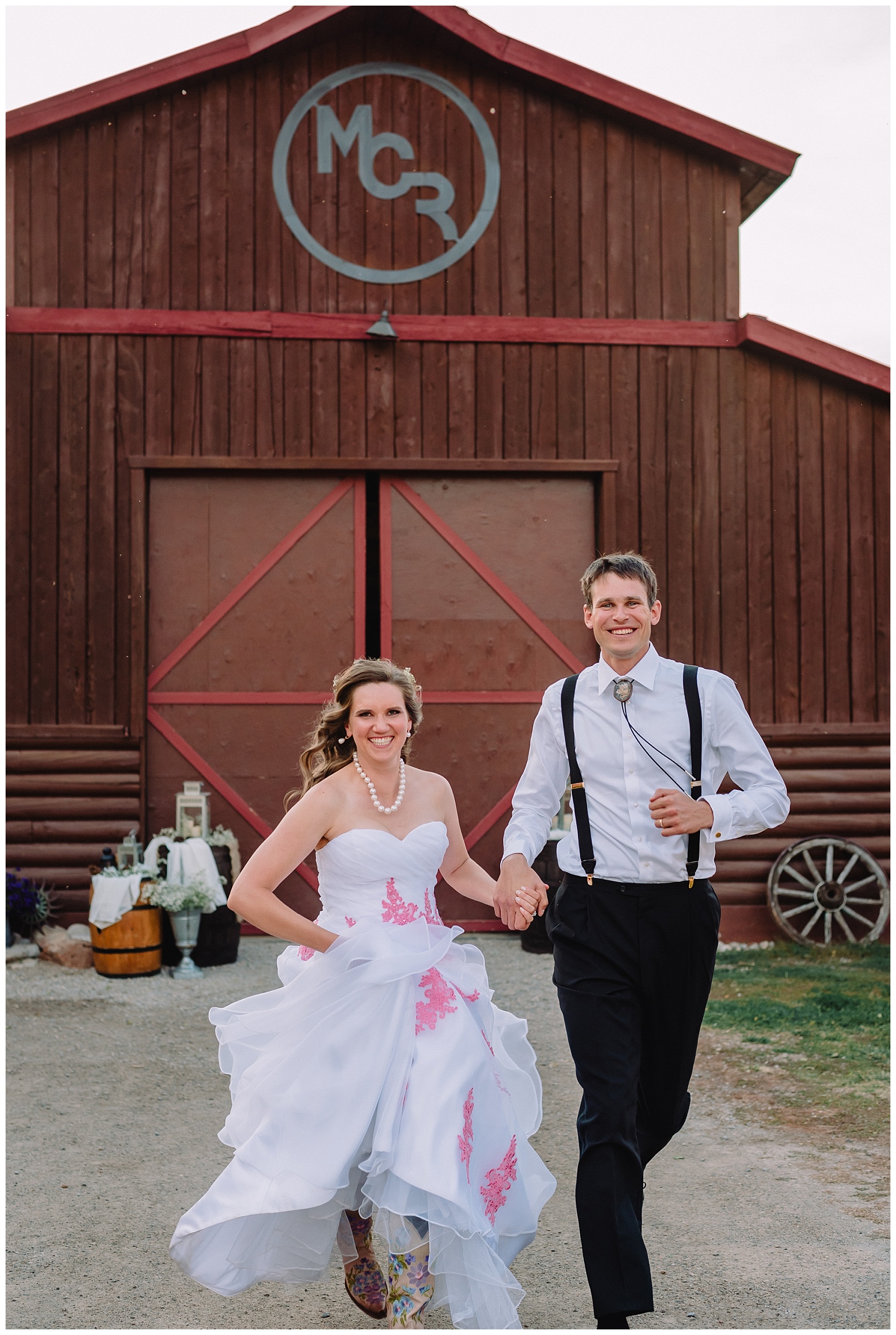 bride and groom wedding portrait running barn