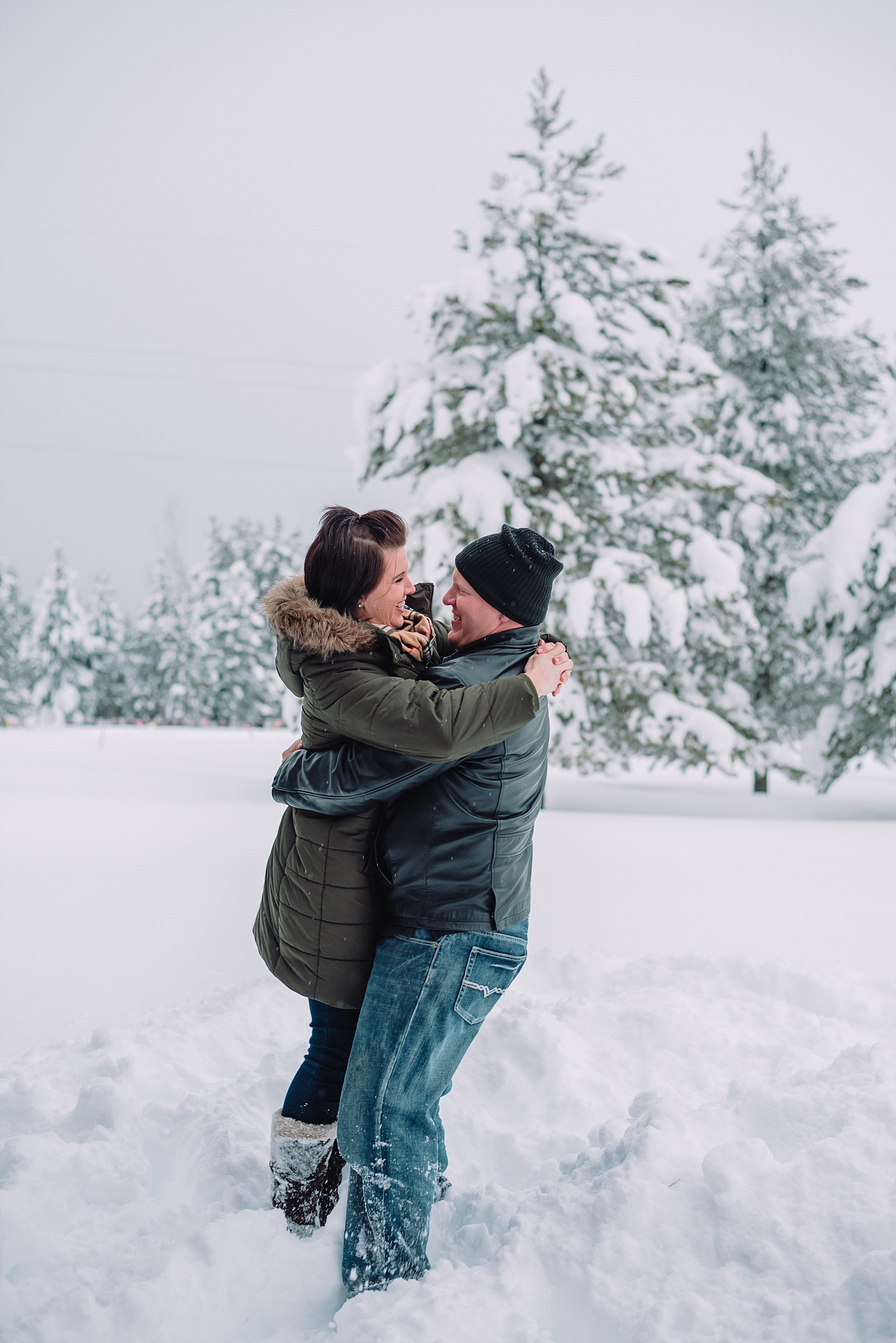 engaged couple fun in the snow