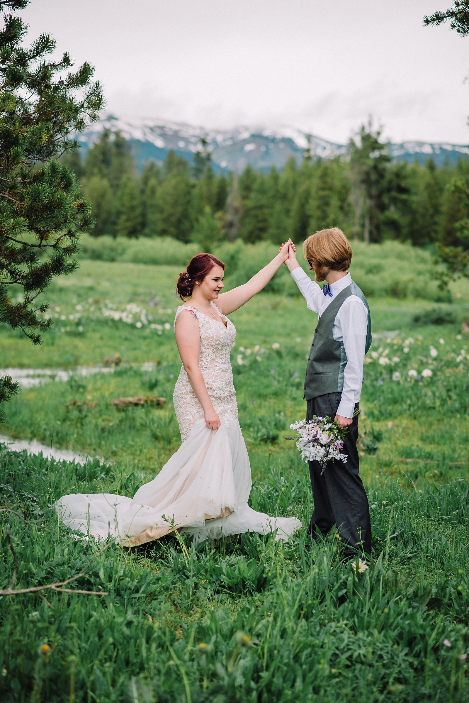 wedding couple dancing in a mountain meadow