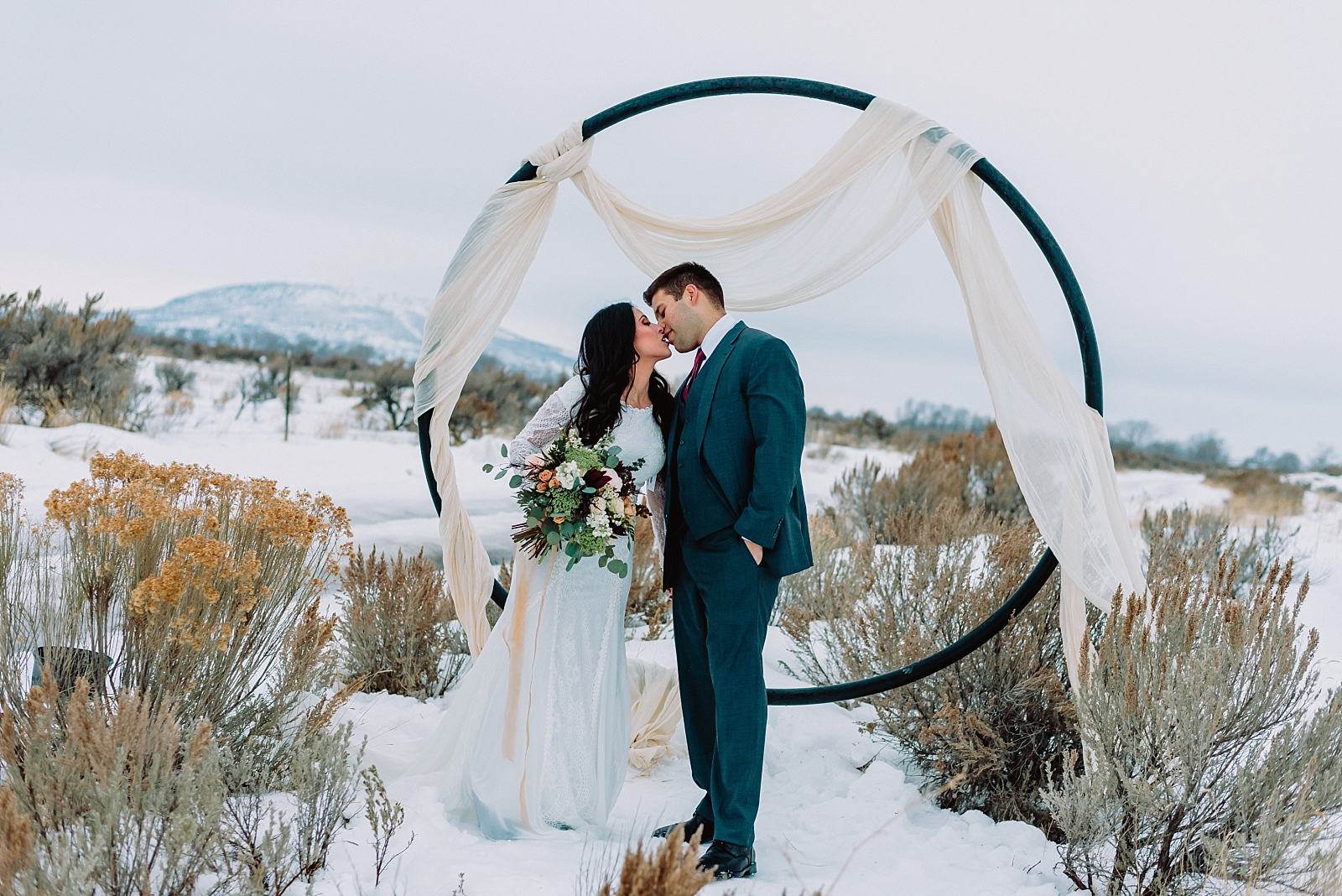 bride and groom kissing winter wonderland elopement