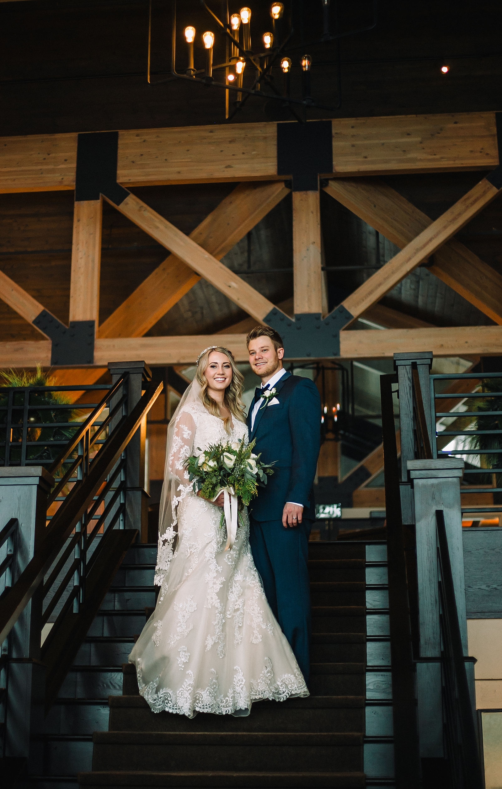 bride and groom on steps teton pines wedding