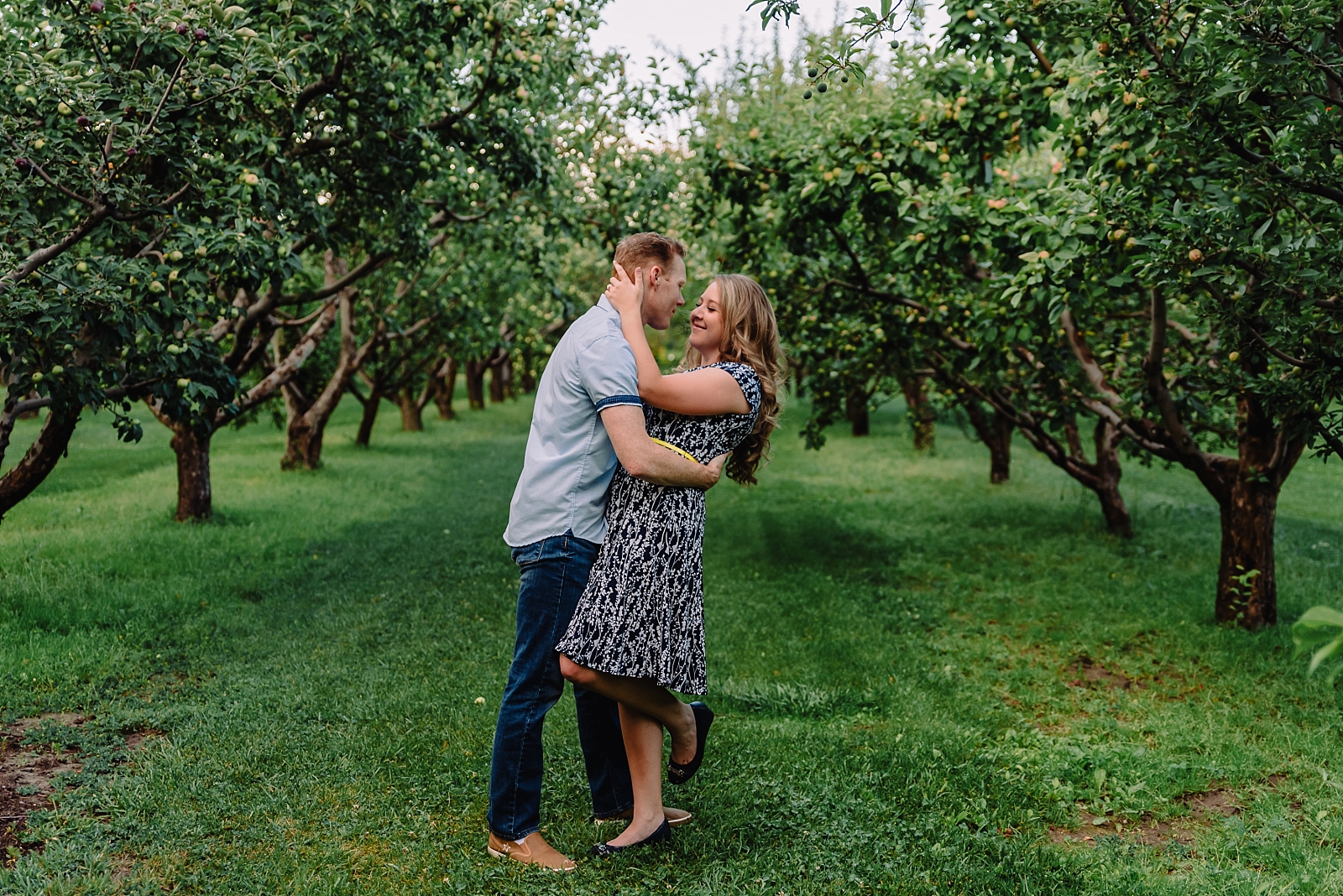 couple dancing in apple orchard rexburg engagement