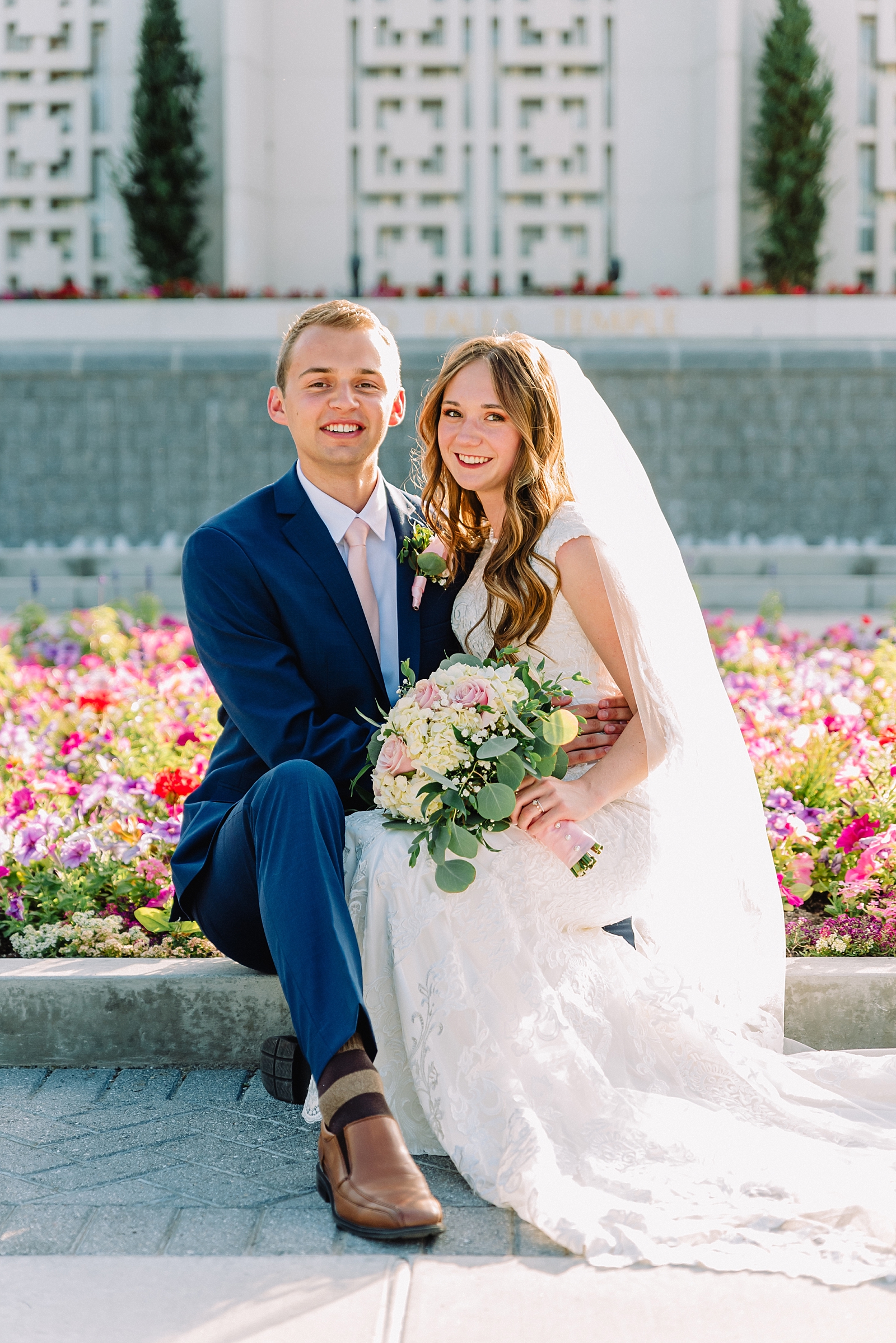 bride and groom in front of LDS temple