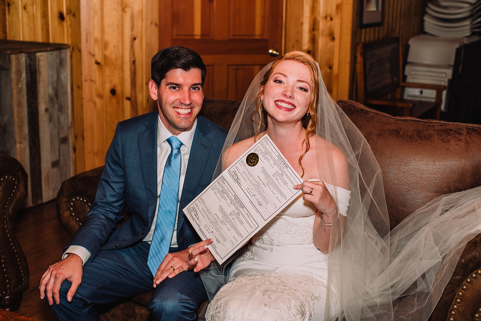 bride and groom with wedding certificate