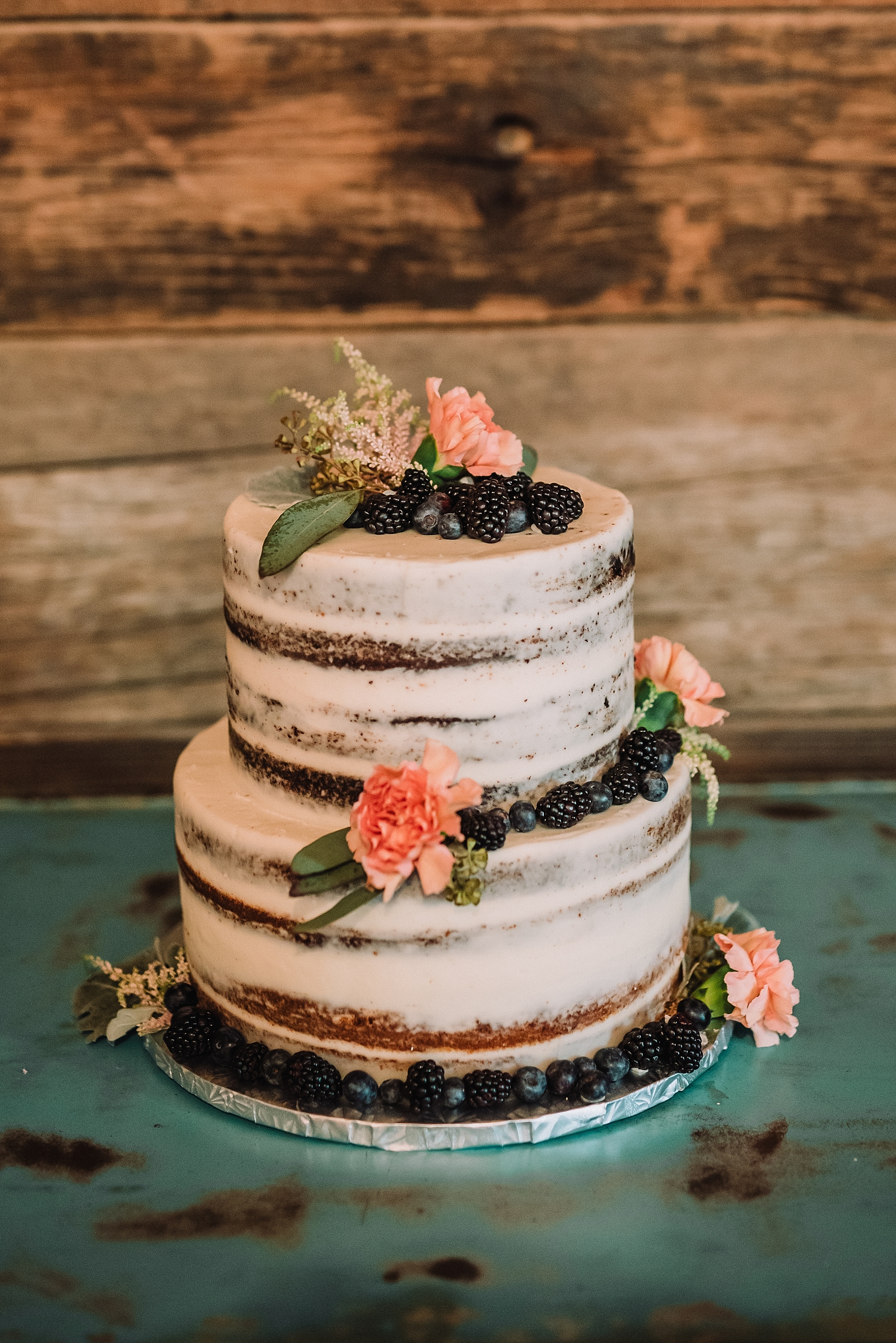 rustic naked wedding cake with berries
