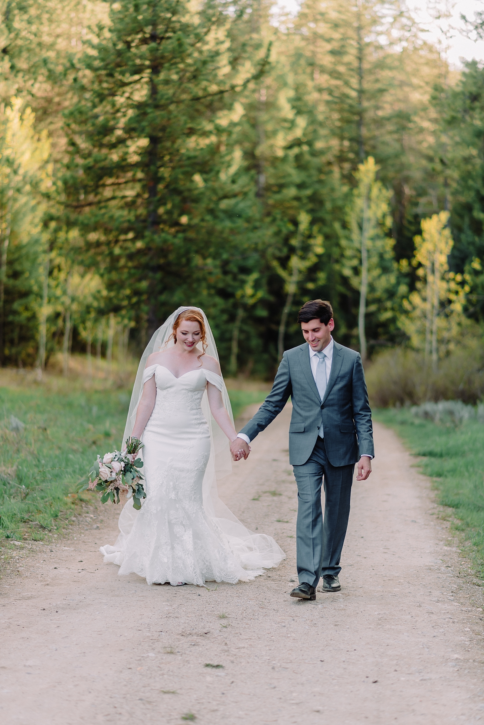 bride and groom walking hand in hand wedding