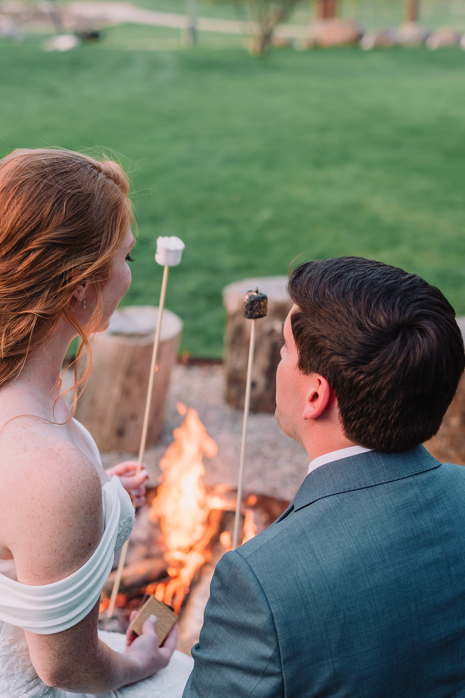 bride and groom with marshmallows and campfire