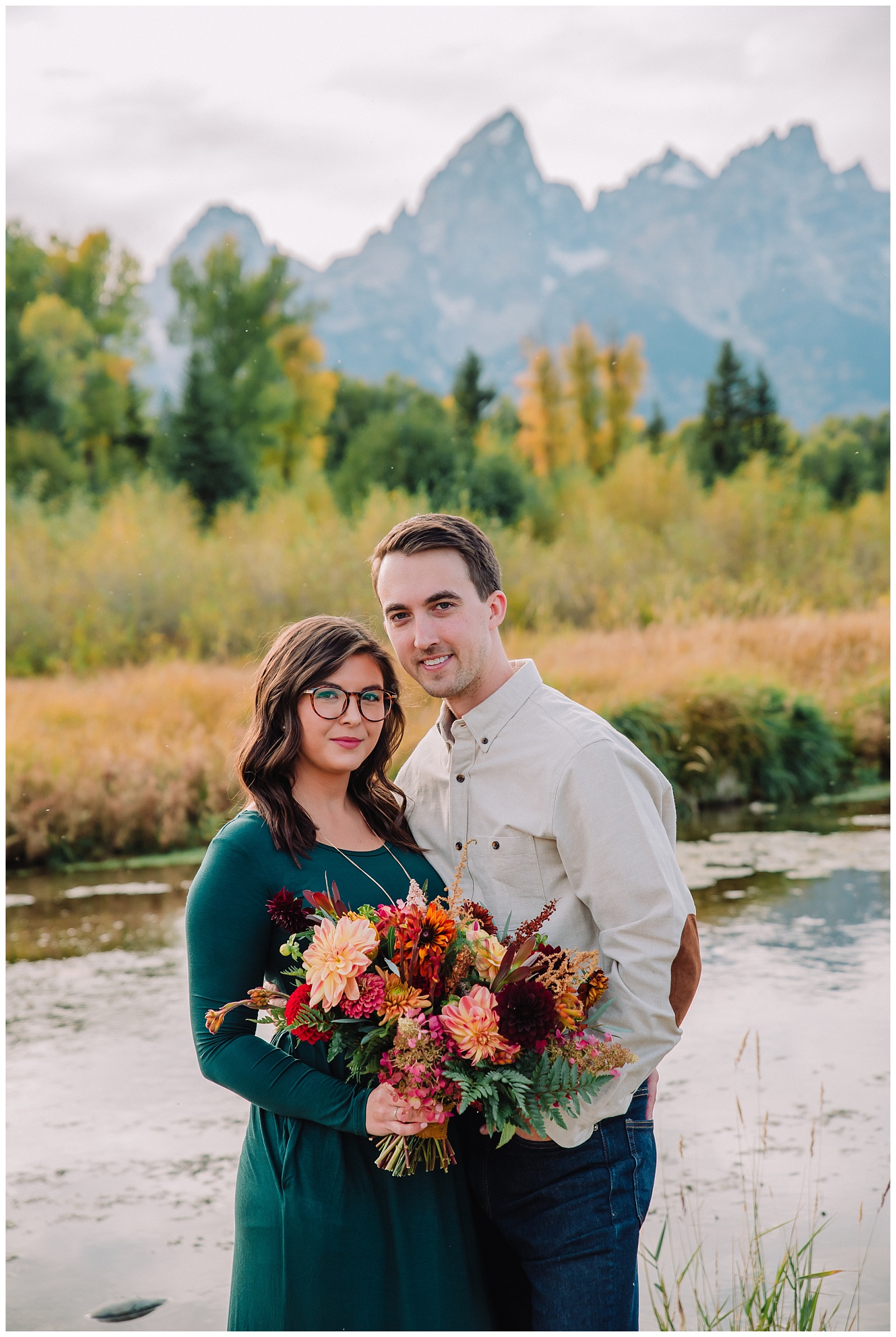 husband and wife with bouquet in mountains