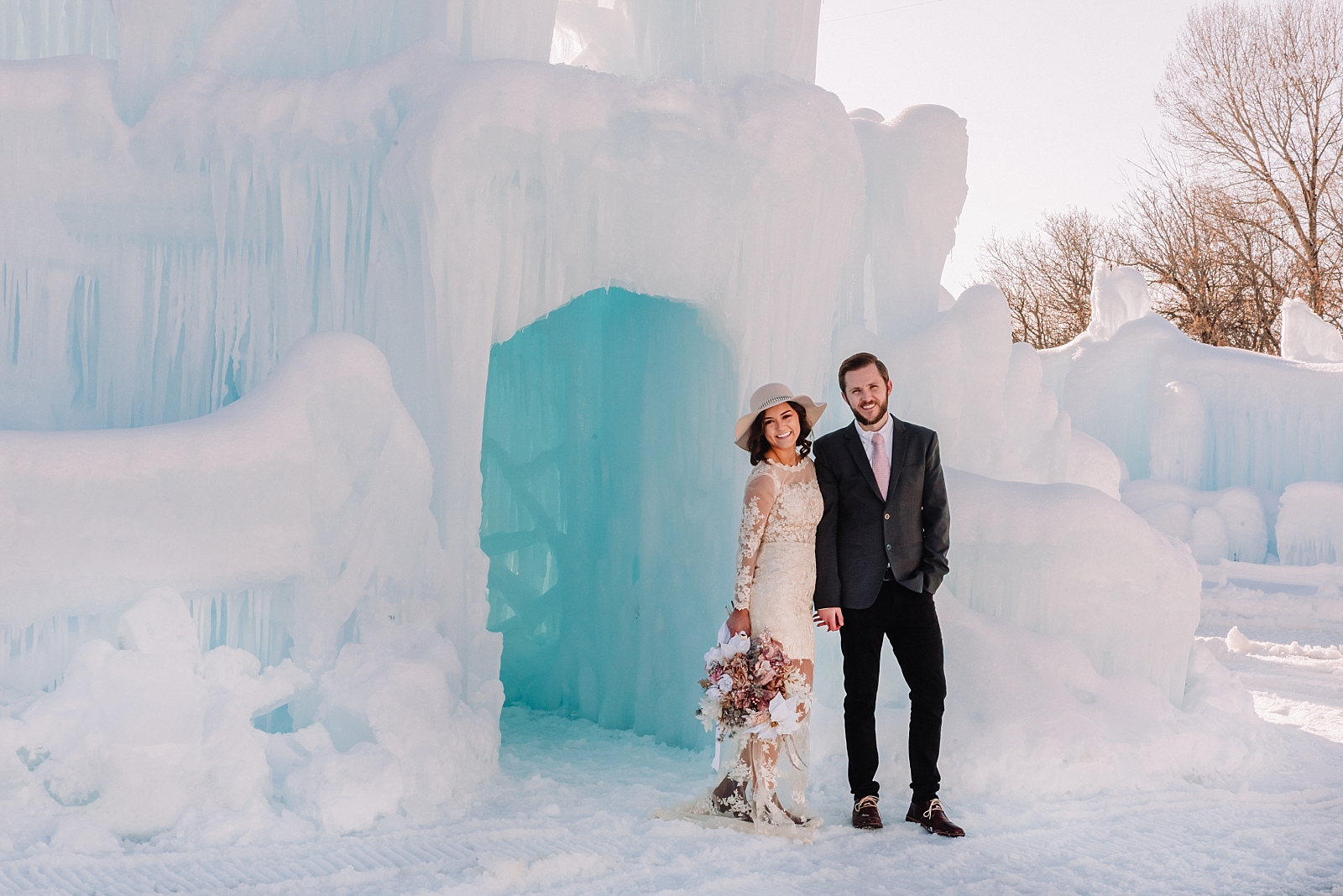 bride and groom in front of ice palace