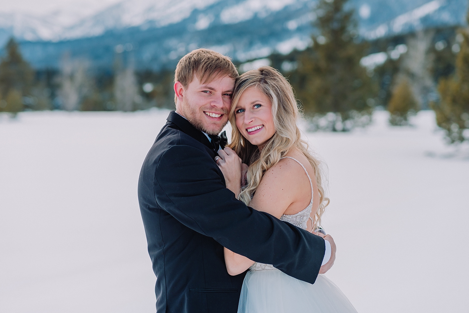 bride-and-groom-hugging-each-other-snowy-mountain-elopement-bridal-session-jackson-hole-wedding-photography