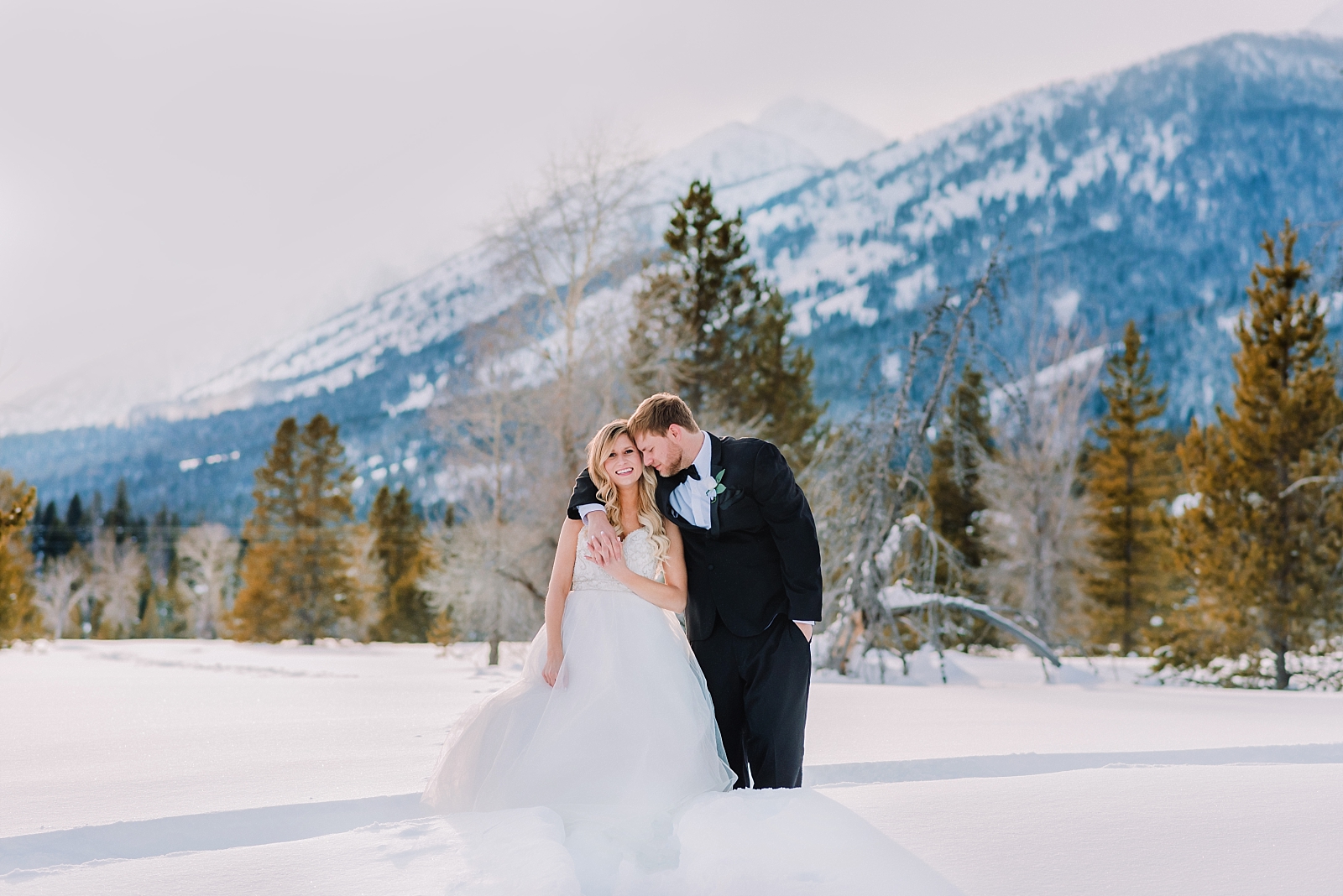 elopement-in-the-tetons-grand-teton-national-park-couple-under-the-mountains-snow-winter-bride-and-groom-jackson-hole-wyoming