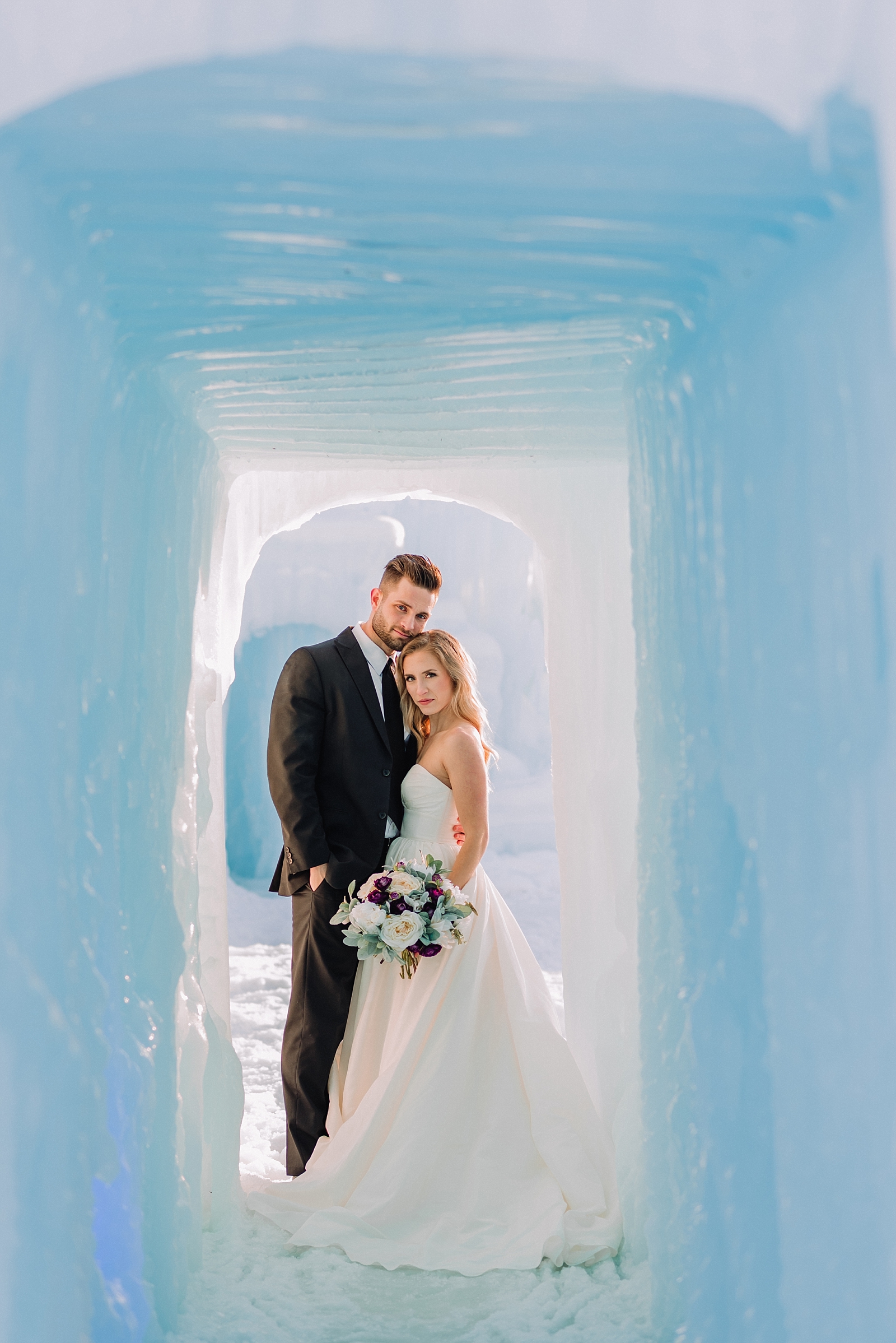 bride and groom side hugging in ice palace tunnel