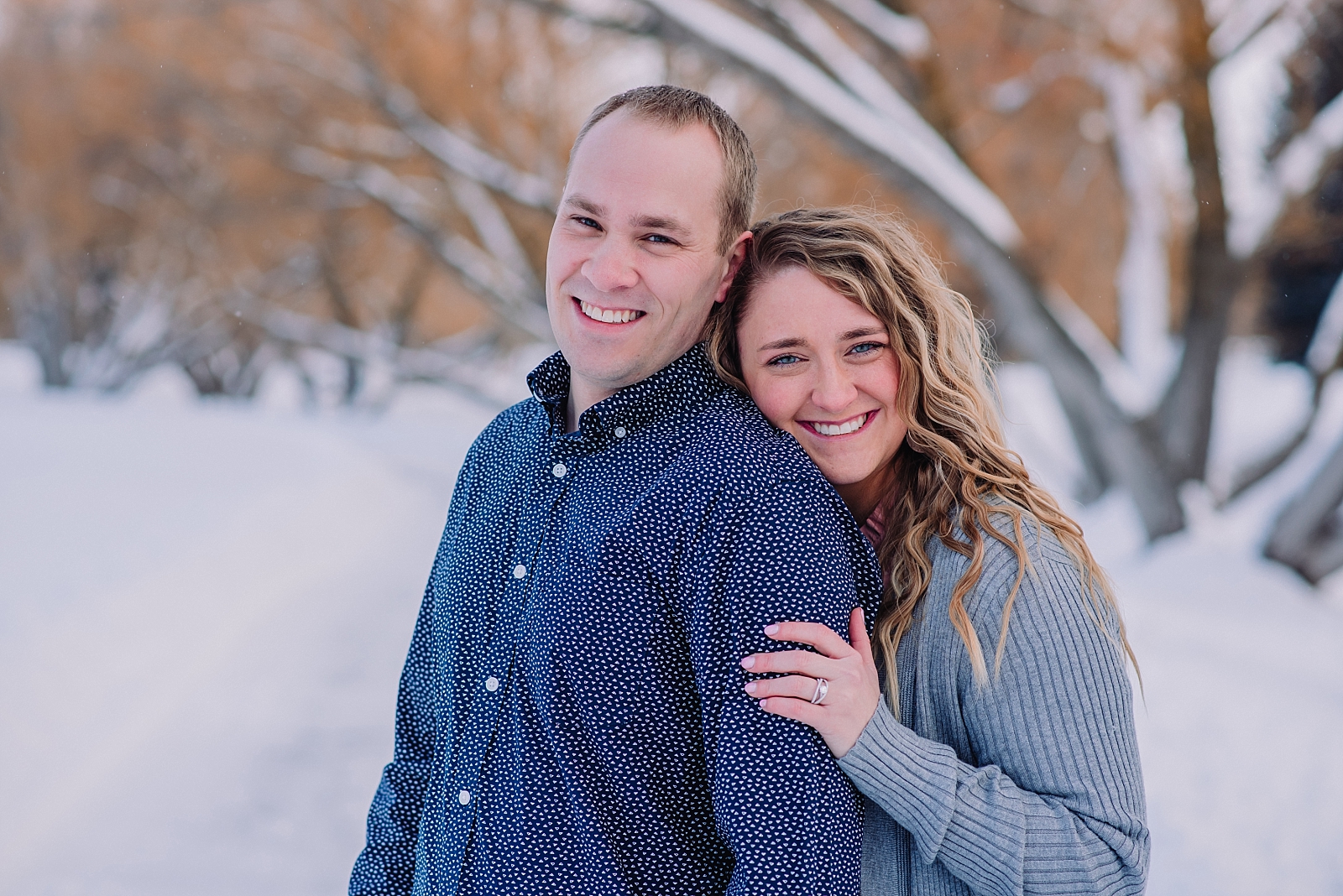 engaged couple posing ideas and prompts hugging each other cuddled engagement photos idaho falls freeman park snow